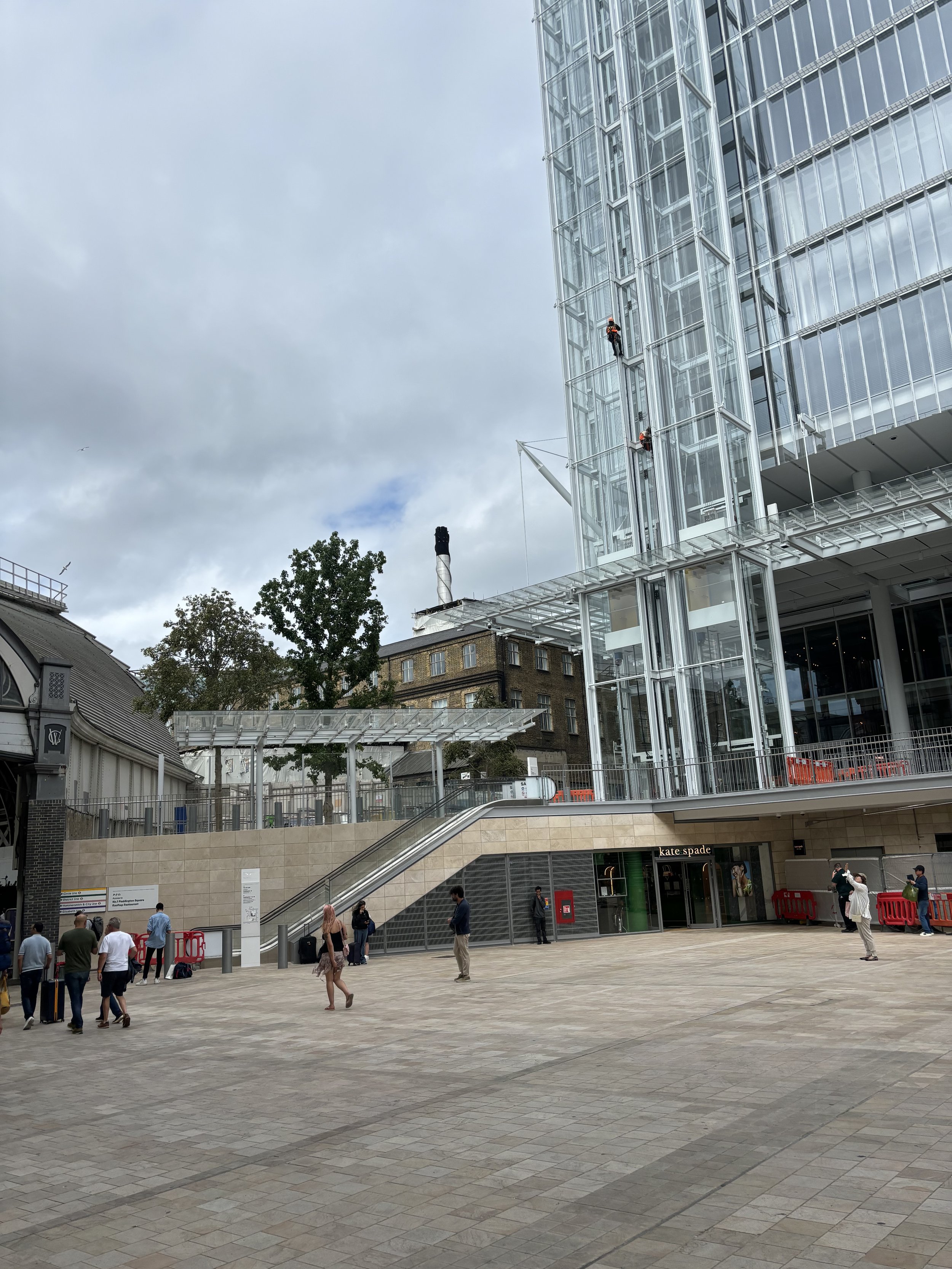 PADDINGTON - A HUGE CHIMNEY SHOWING IN THE BACKGROUND BEHIND THE TRAIN STATION