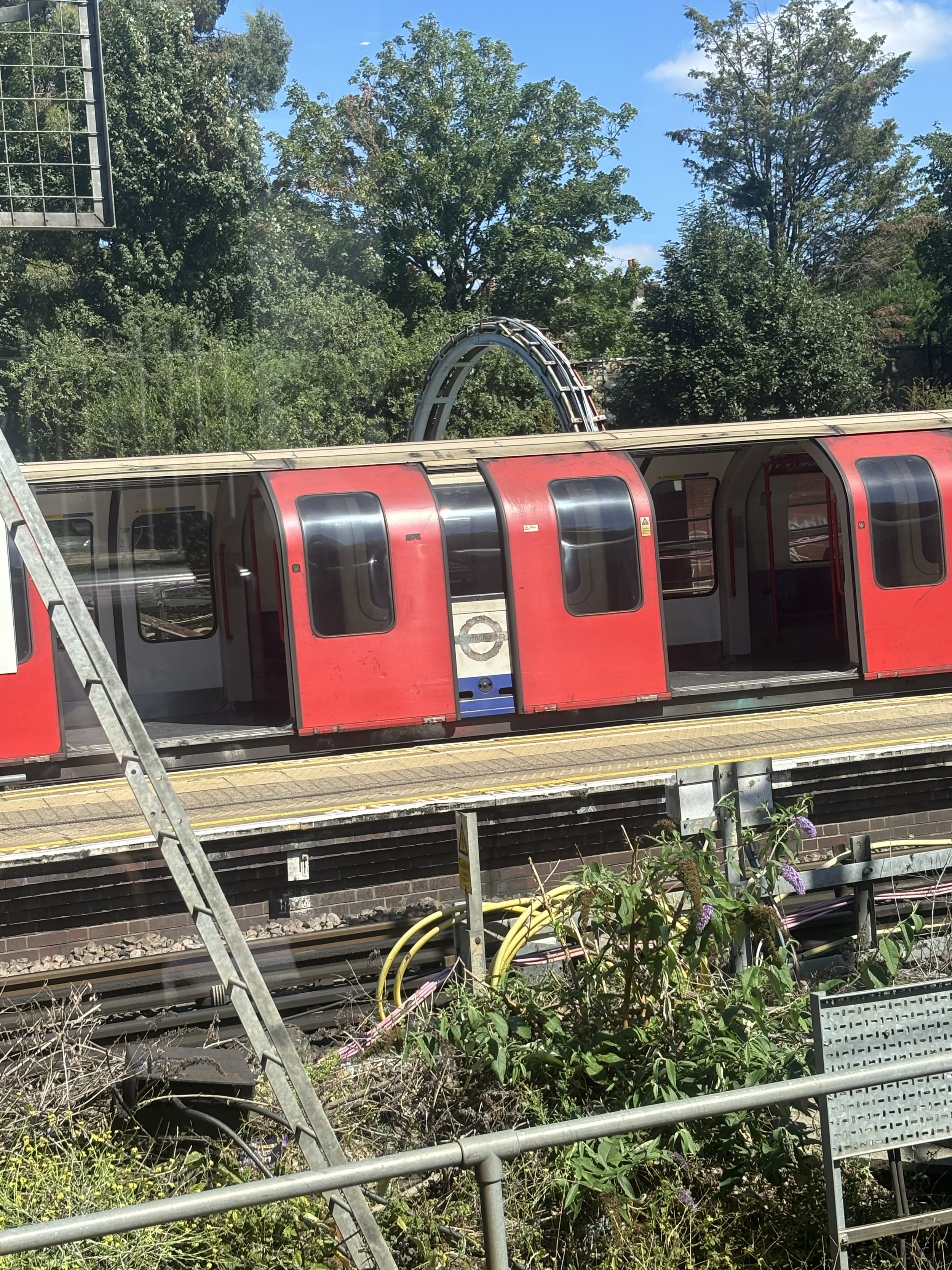 EALING. YOU WILL SEE BEHIND THE TRAIN IS A COIL OF A HUGE NUMBER OF ELECTRICITY CABLES
