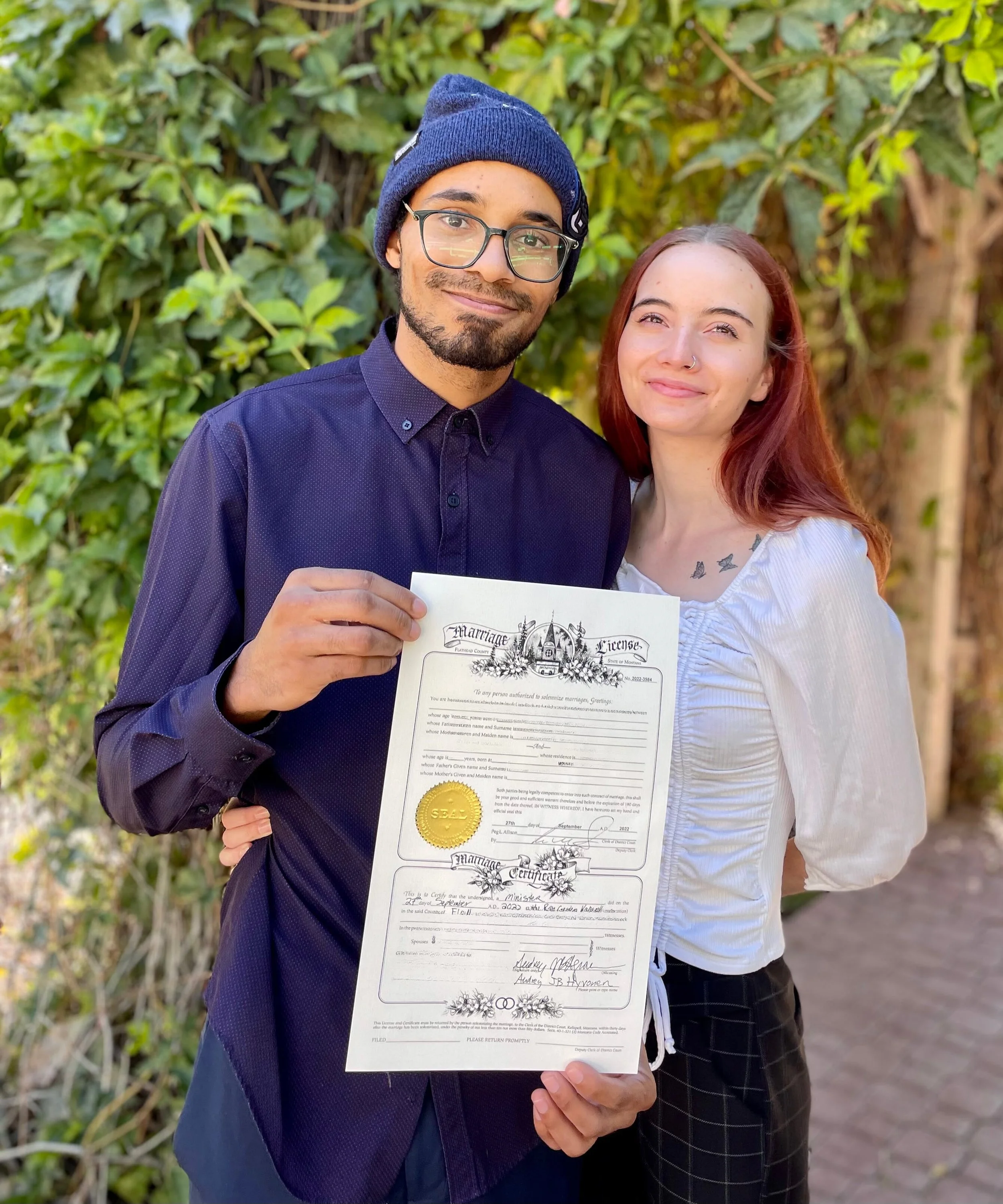 Breaded groom with cap and longhaired bride with tattoos pose with their marriage license-JudahAndAnelisaAtTheRoseGarden.9.27.2022 - Edited-min.jpg