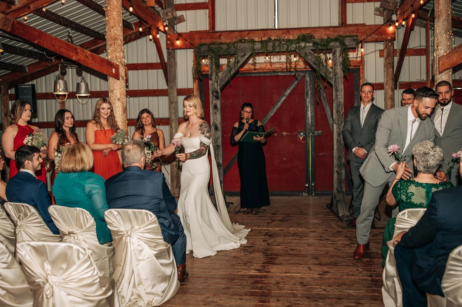 Flower ceremony at an indoor ceremony in a rustic barn