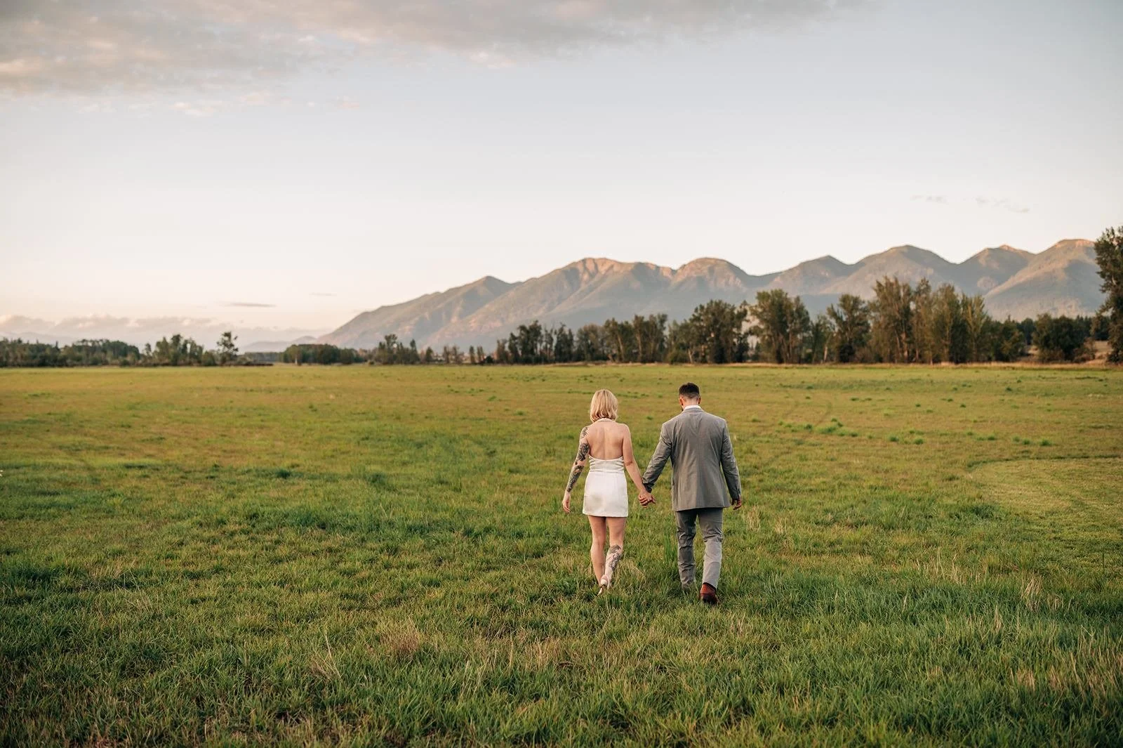 walking away in the field after the wedding