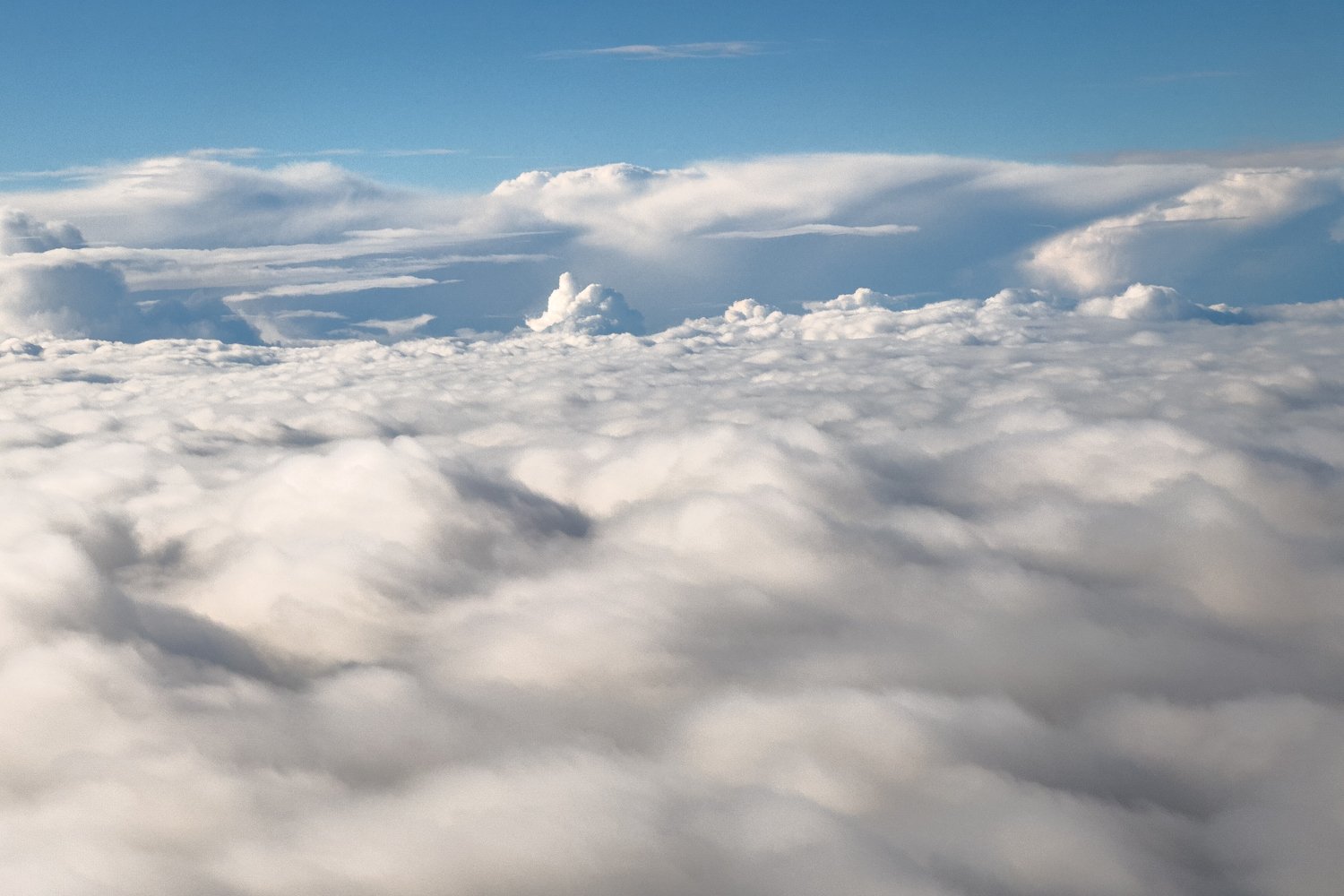  The mixed cloud conditions below us as we fly south. 