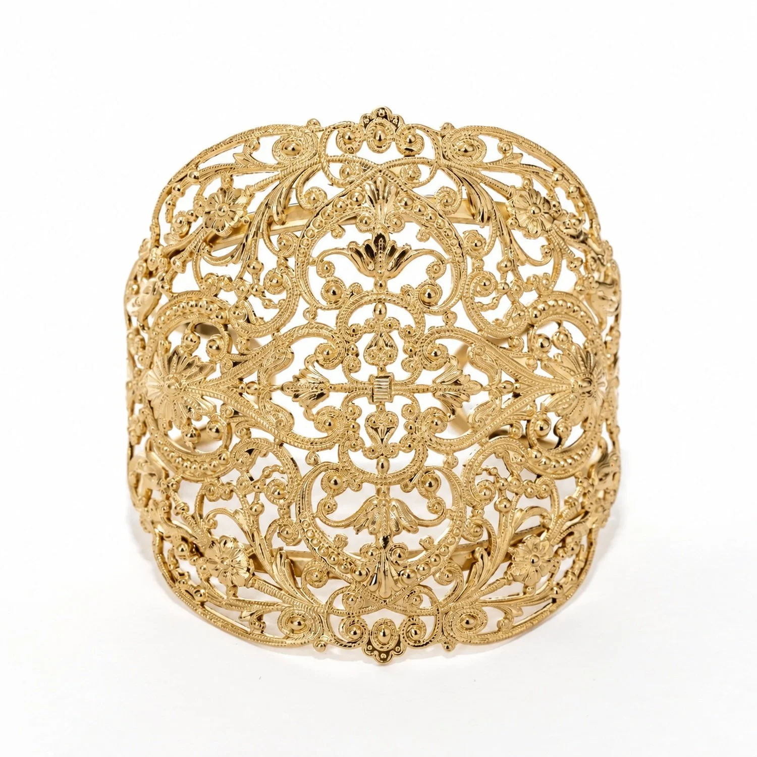 A closer look at the Junon " cuff bracelet ," featuring details of the pattern and gold finish