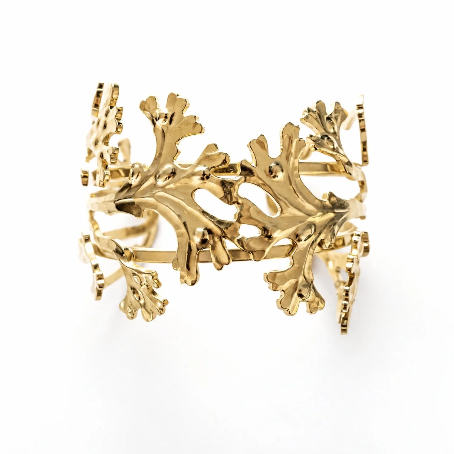 Close-up of the coral- cuff bracelet , showing the pattern and gold finish in detail
