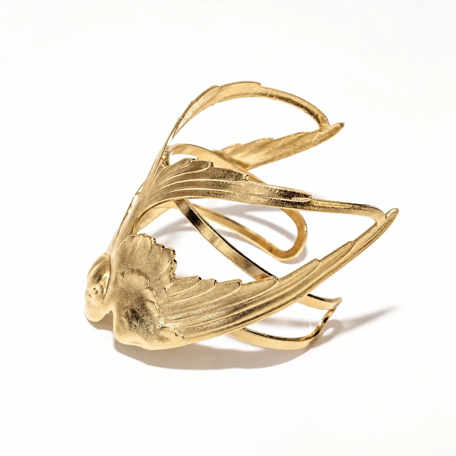Close-up of the " cuff bracelet " swallow, showing the pattern and gold finish in detail