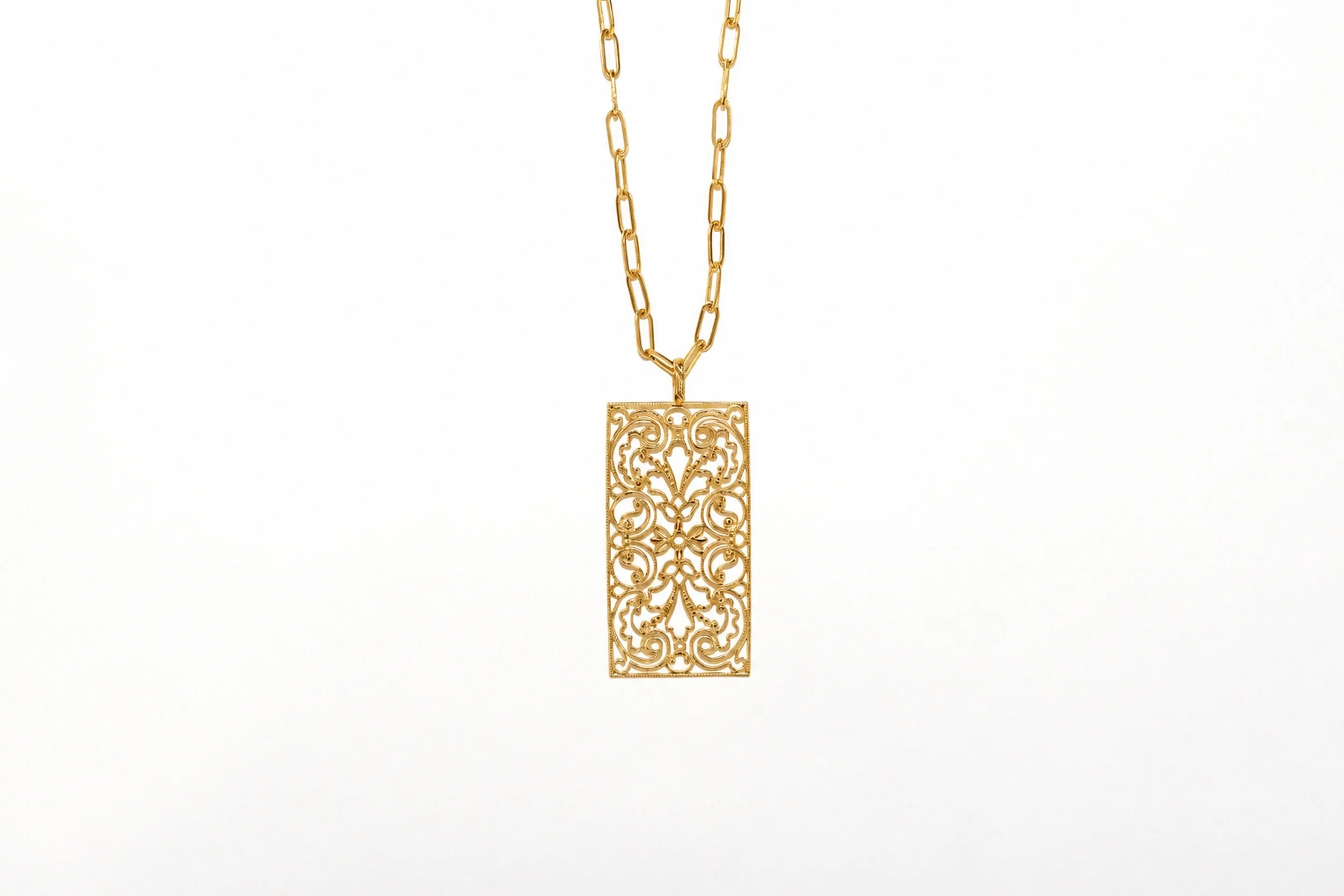 A closer look at the Sirocco filigree necklace, featuring a close-up of the design and gold finish
