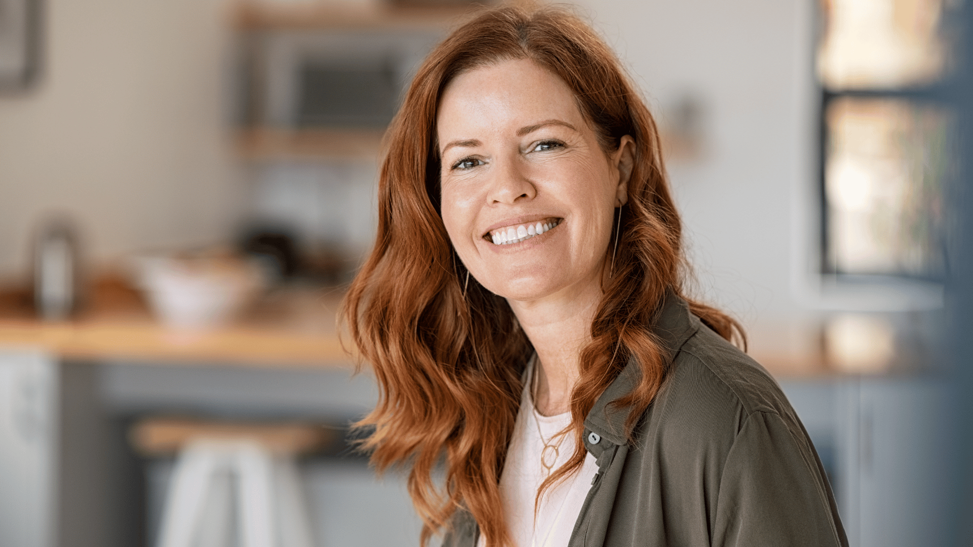Middle aged woman looking and smiling at camera