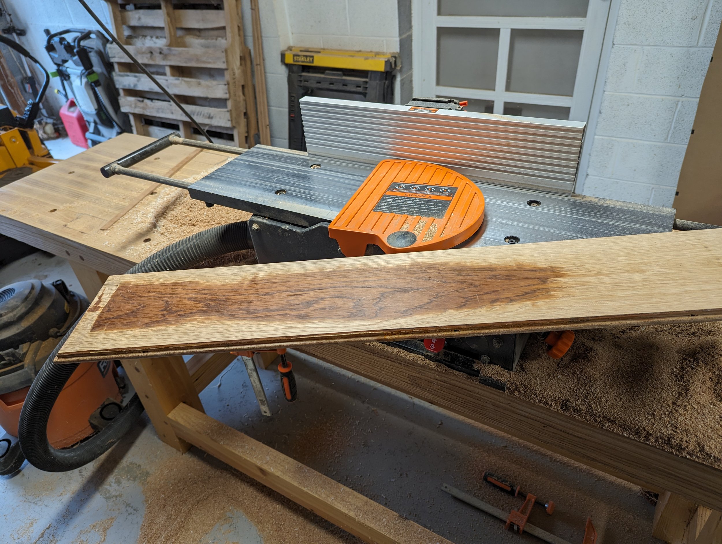  After the nails were removed, the boards were run through the jointer to remove the old finish and get the surfaces completely flat before they could be planed. This process takes an extremely long time, as each pass through the jointer takes off a 
