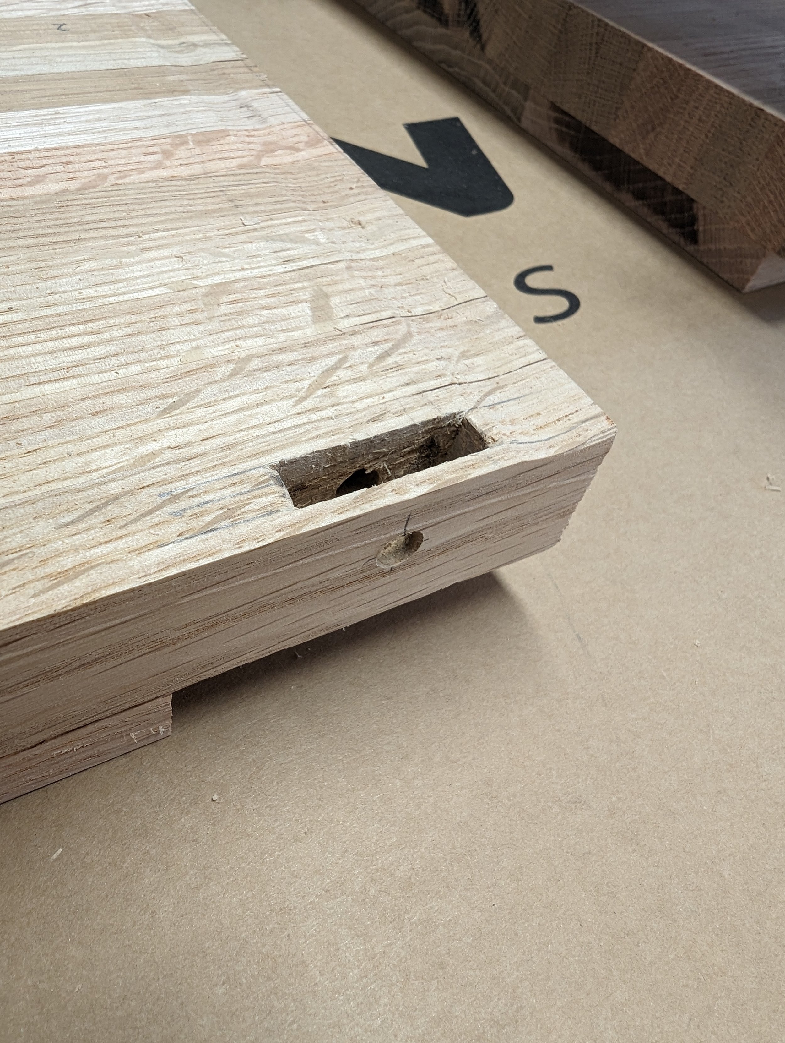  Each mortise was cut to accept the leg tenons. Note the hole drilled from the outside of the table top edge through to other side of the mortise. This was use for the dowel pin during assembly. 