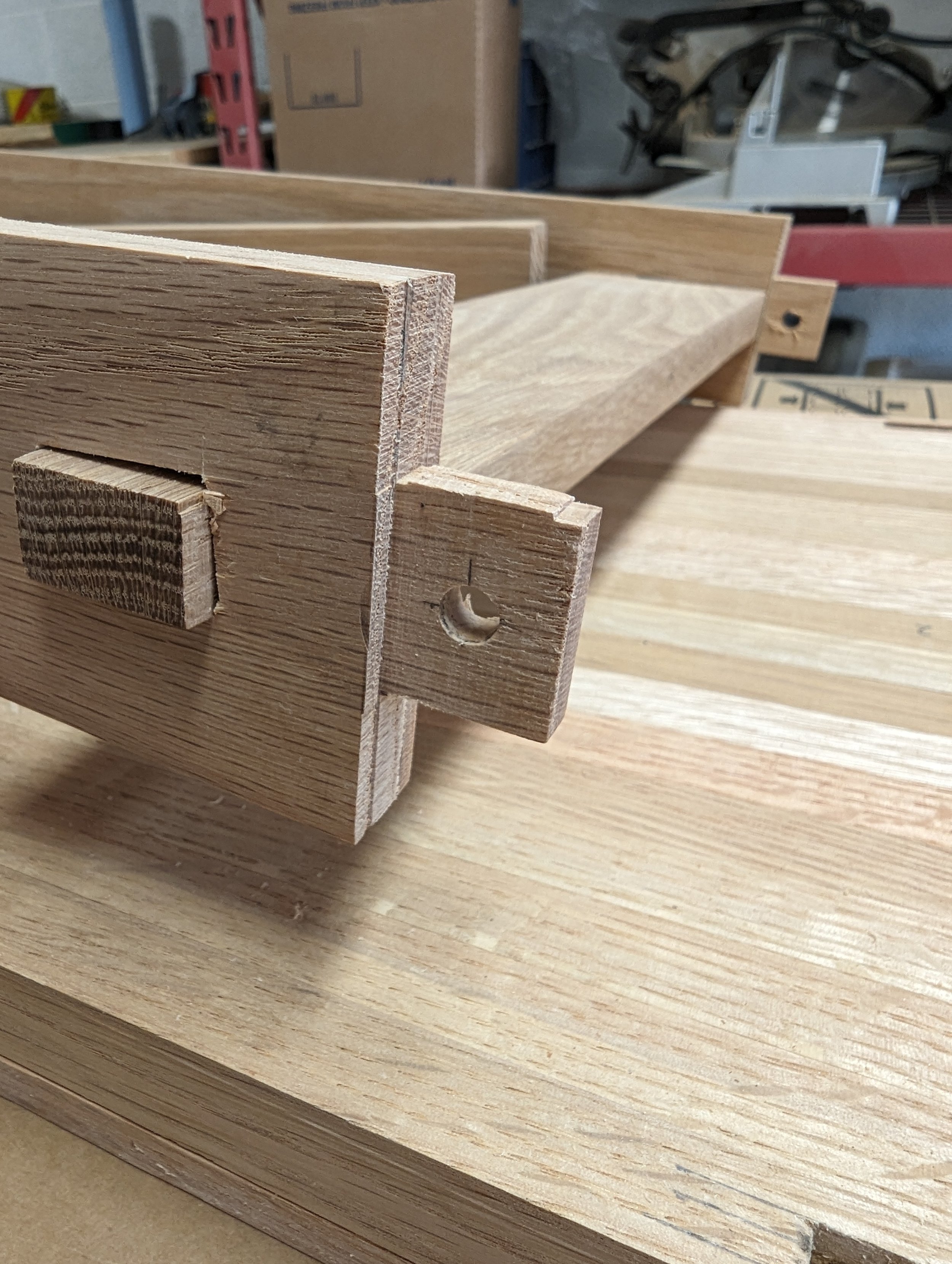  Here’s a view of the leg mortise with the dowel hold drilled 1/32” closer to the tenon shoulder. This difference in hole position provided additional clamping pressure during assembly. The cross member through-tenon is also shown here. 