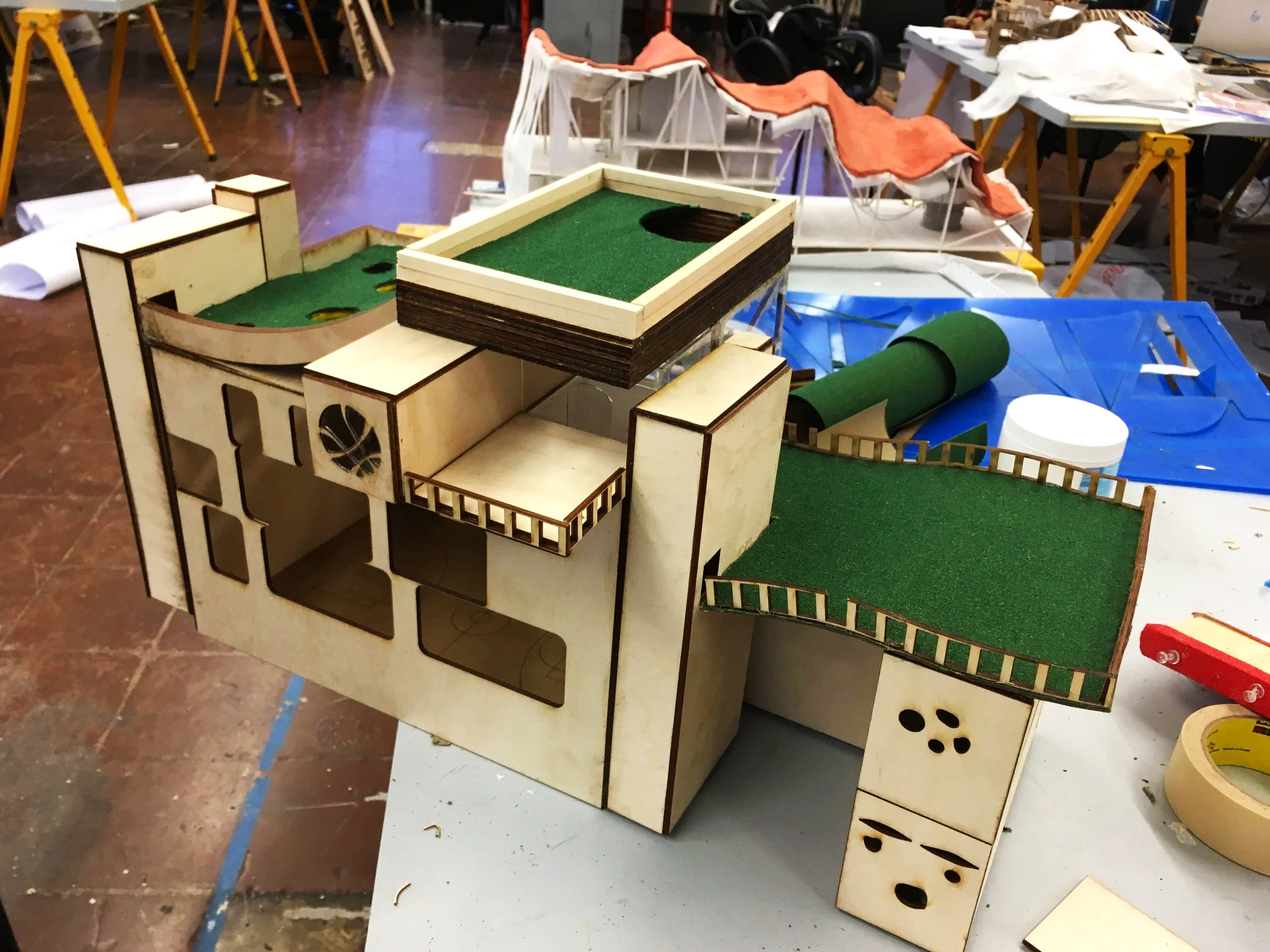 Final model of laser cut 1/8 plywood being assembled and grass patches assembled