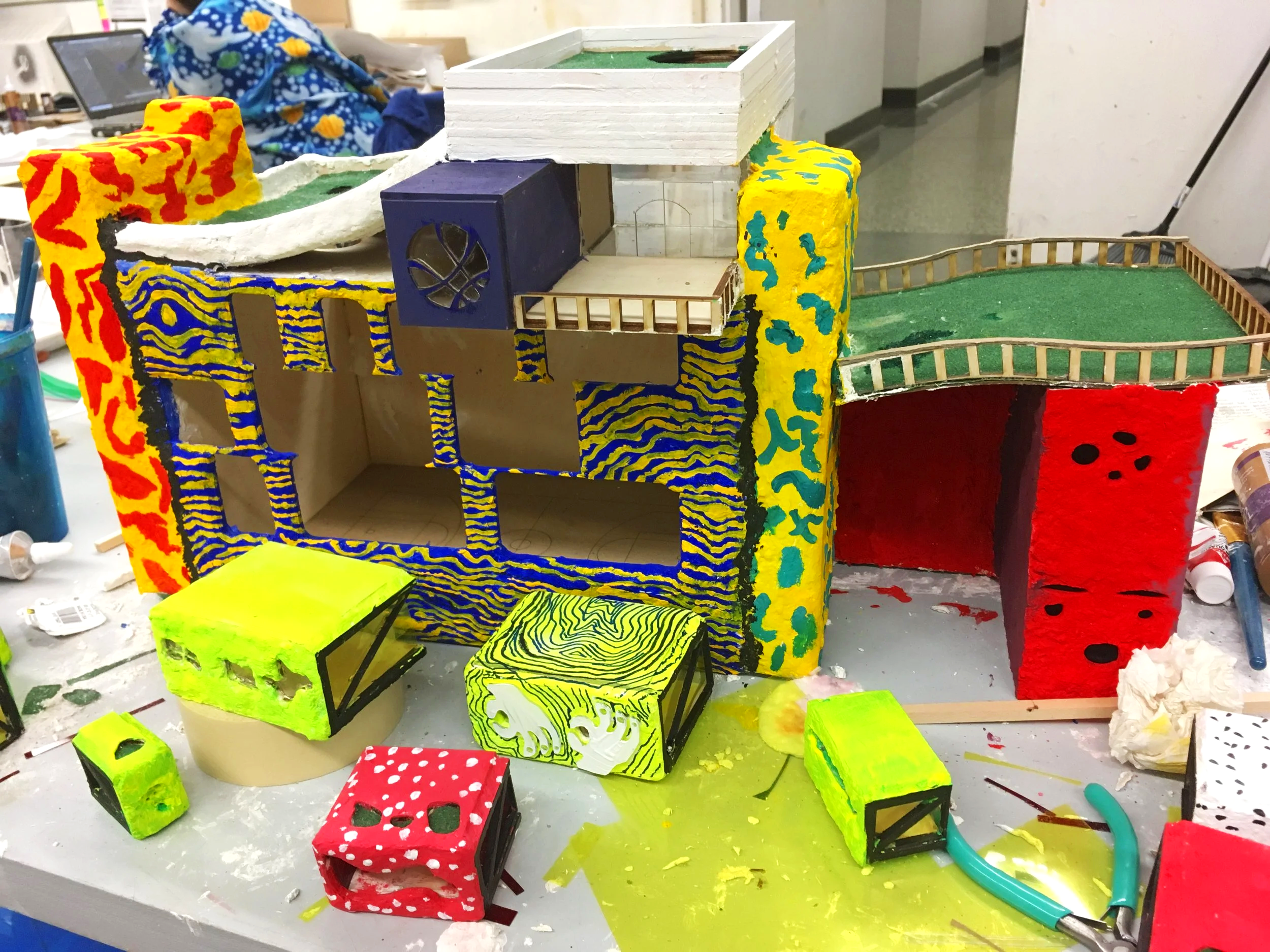 Gouache paint is applied to each of the components and adhered to the structure.