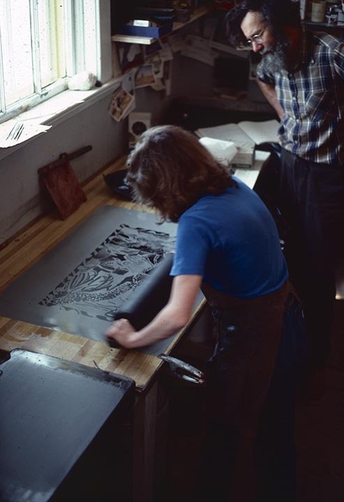 Don Wright watching over Tish Holland as she rolls up her lithographic plate. St.Michael's.