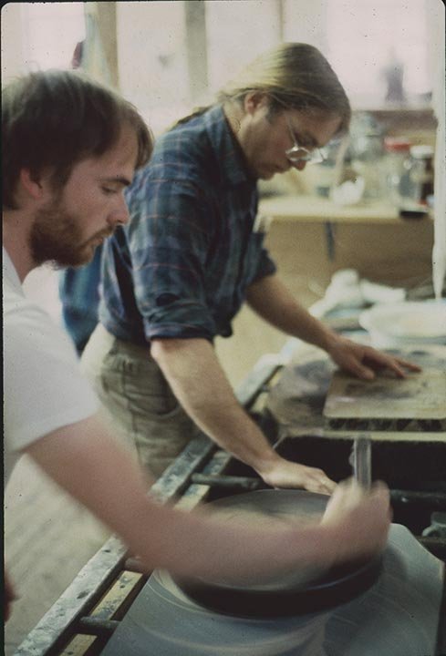 Collin McNee and Jack Botsford graining stones at a lithographic workshop, St.Michael's.