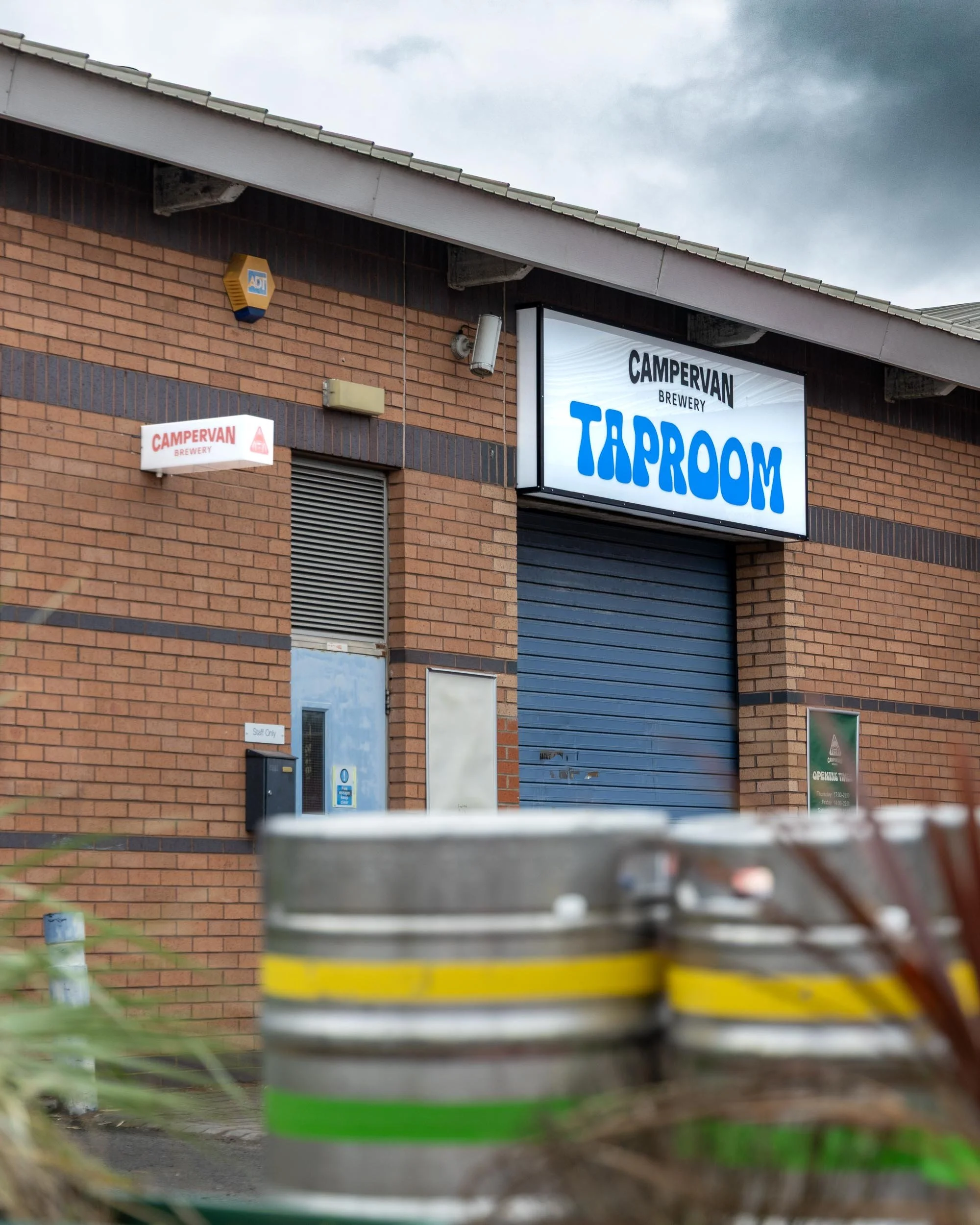 Exterior Illuminated signage over a large shutter door to a brewery.