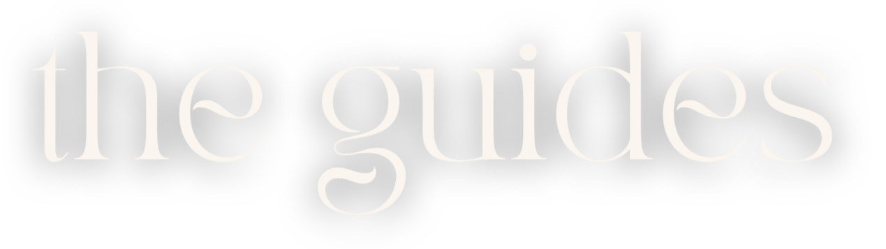 The phrase "the guides" written in large white text on a black background.