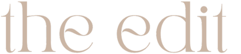 Close-up of text that reads 'the edit' in large, beige letters on a dark background.