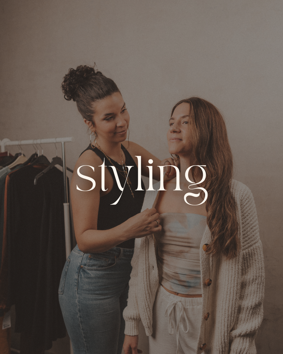 Two women in a dressing room, one helping the other with clothing, with the word 'styling' overlayed.