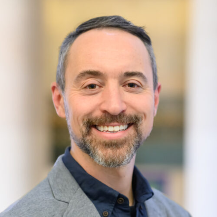 Headshot of Professor Chris Rabe, smiling