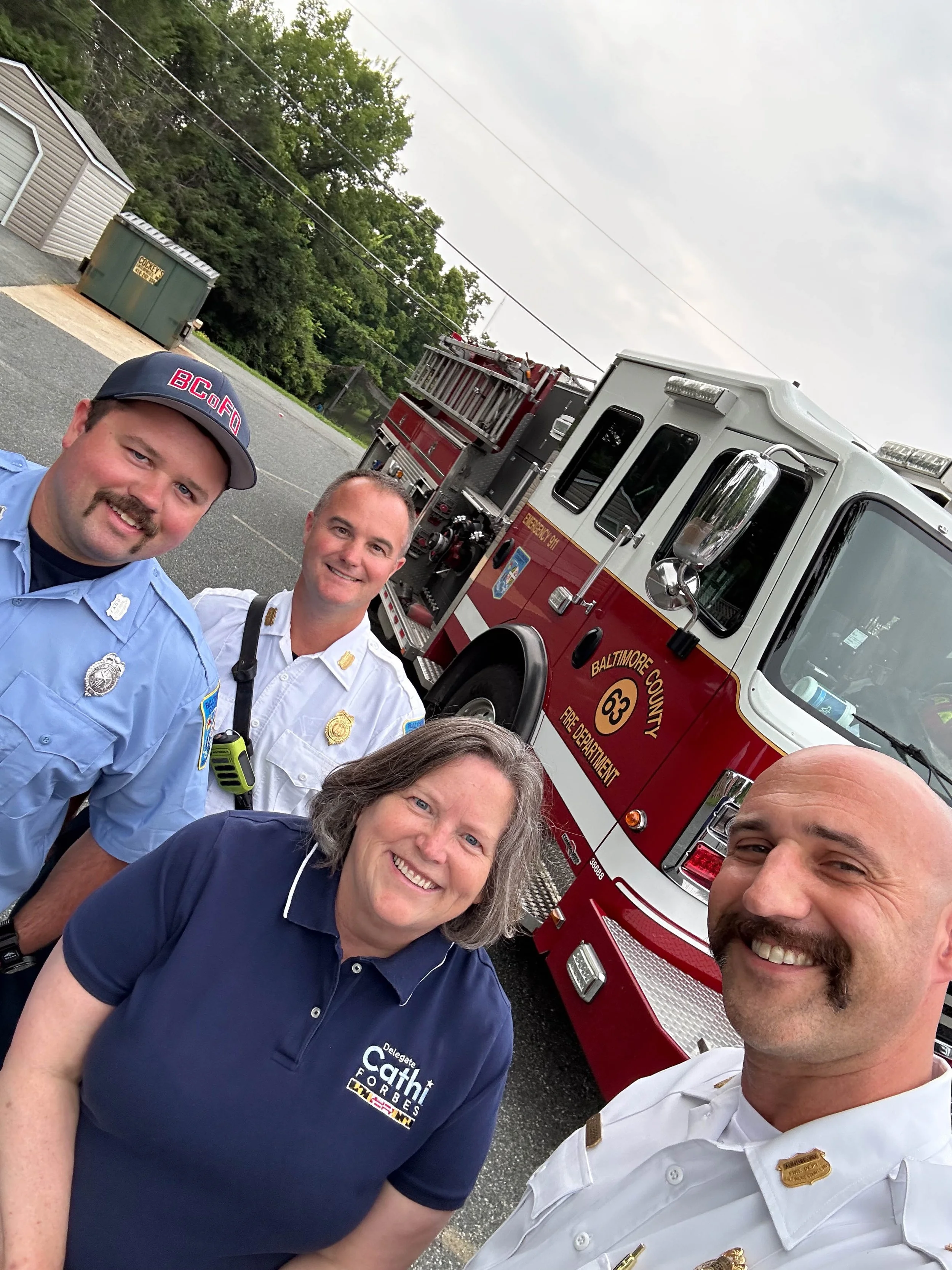 Cathi with firefighters.jpg