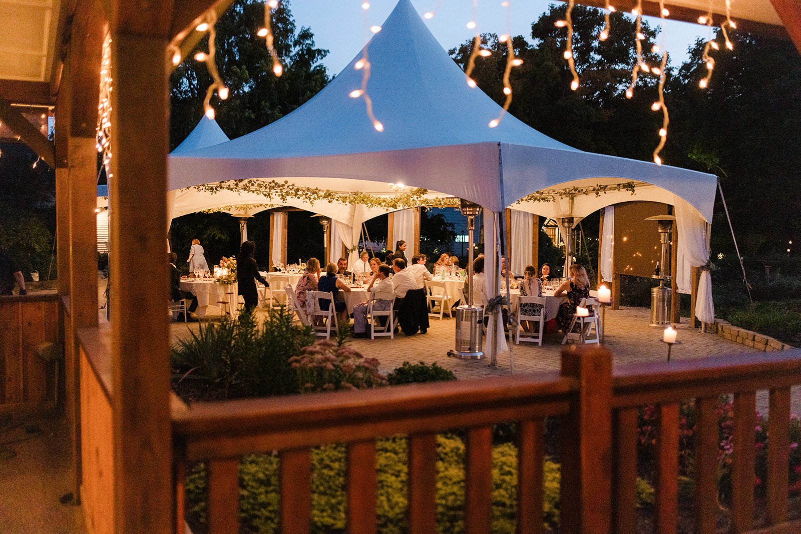 string lights and a tent in a romantic wedding reception