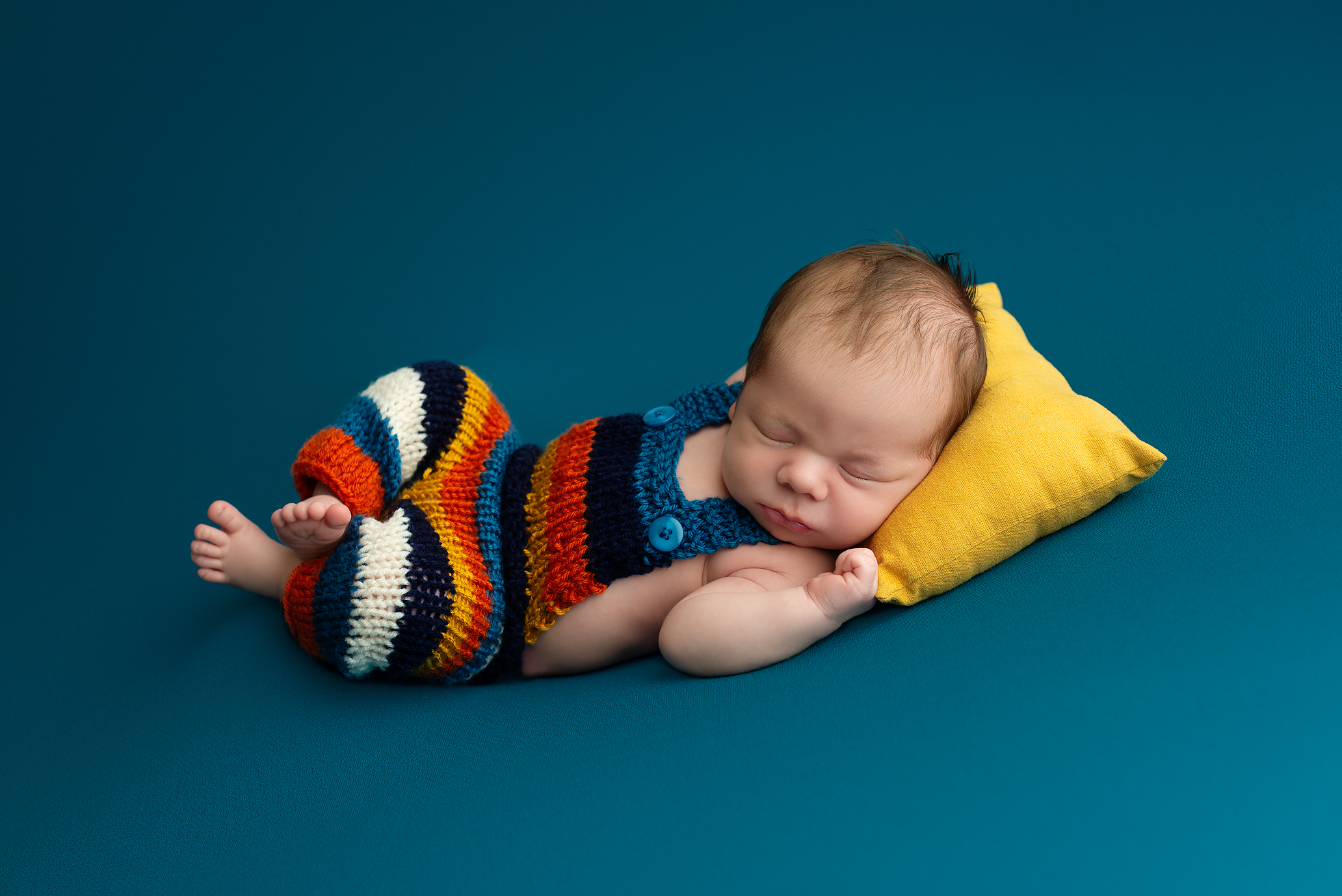 newborn-boy-kingston-photographer-teal-blanket-striped-knit-overall-fall-colours.png