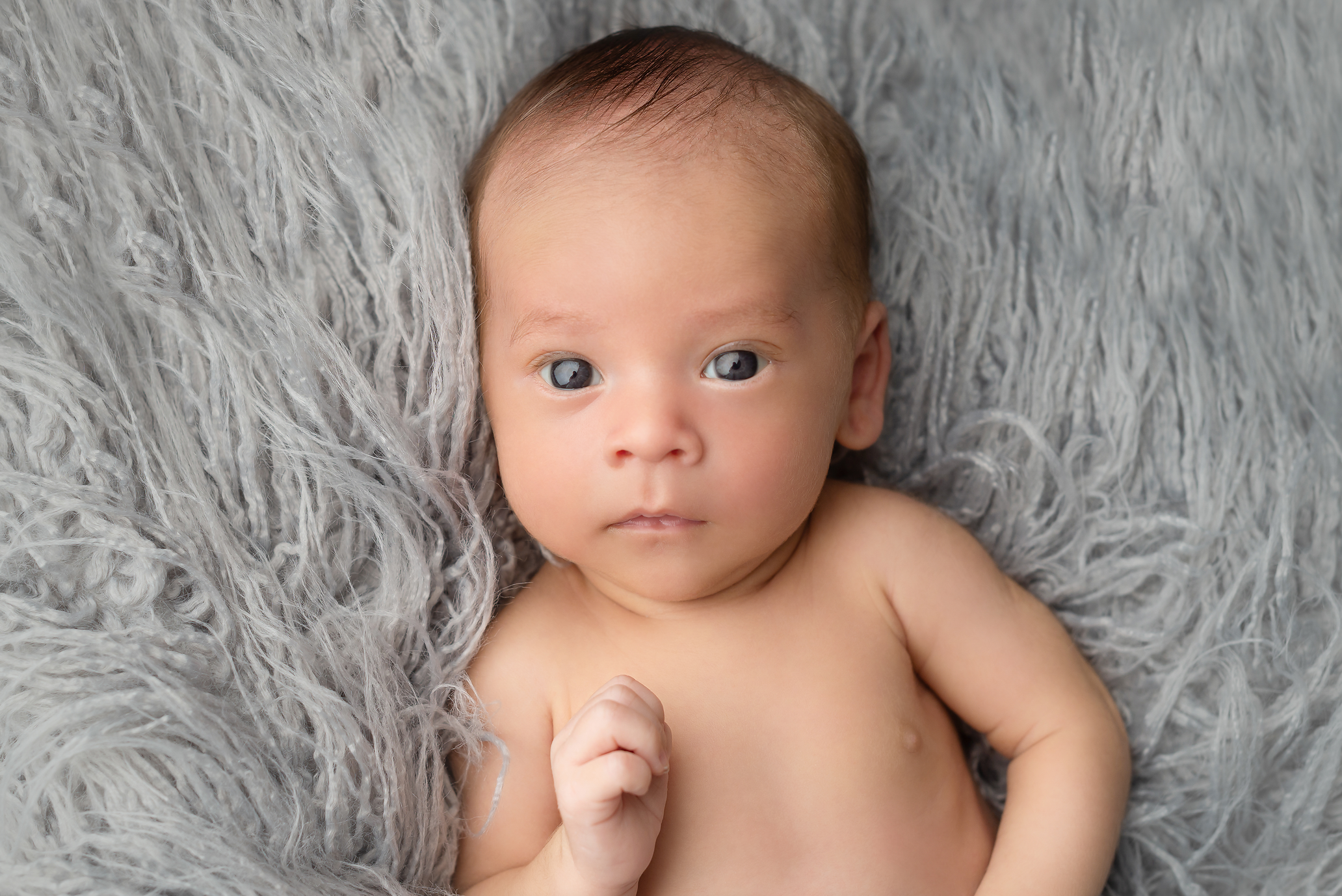 baby boy on grey flokati rug in Kingston family portrait studio