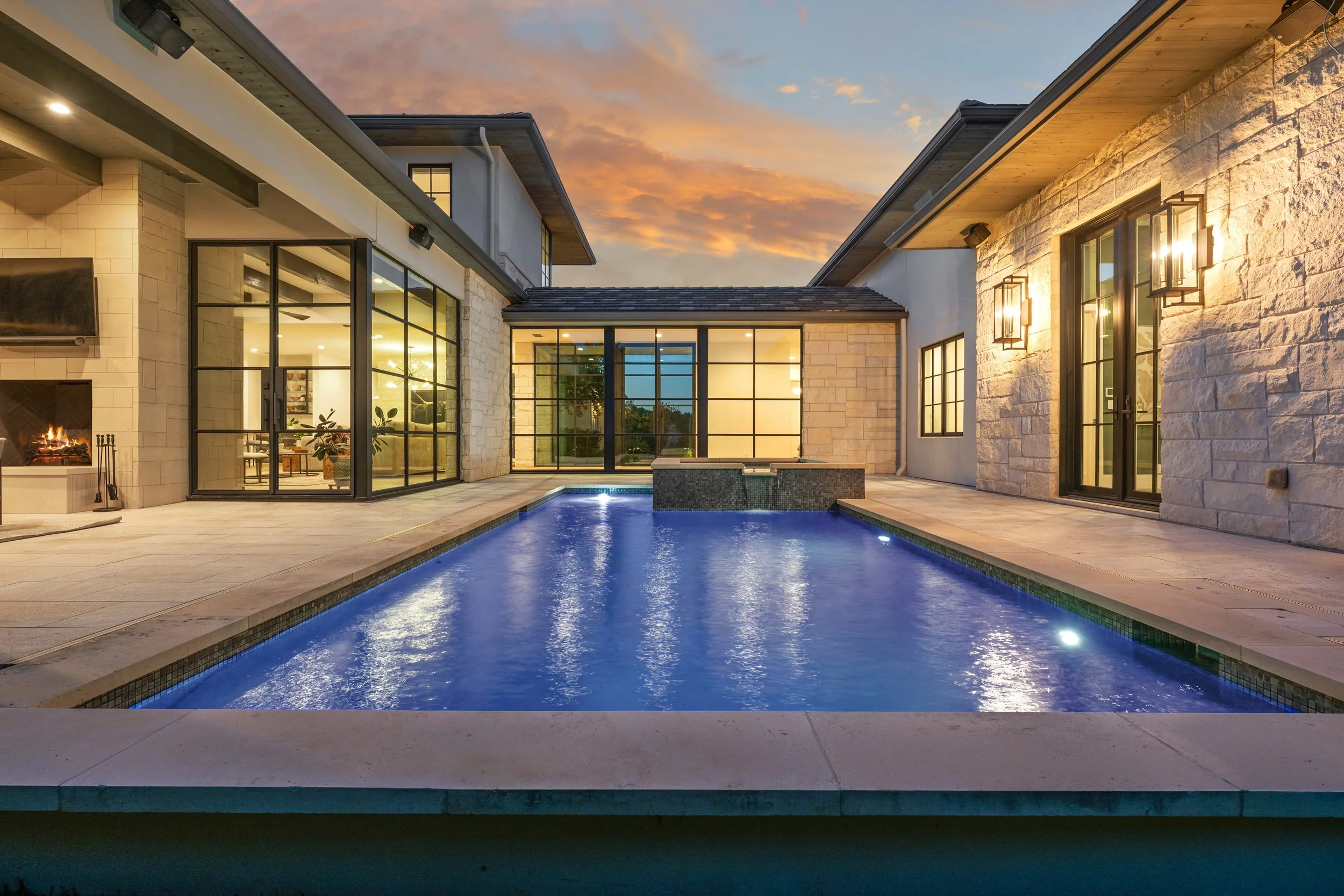 Twilight photograph of a contemporary home in Austin Texas showcasing the beautiful pool