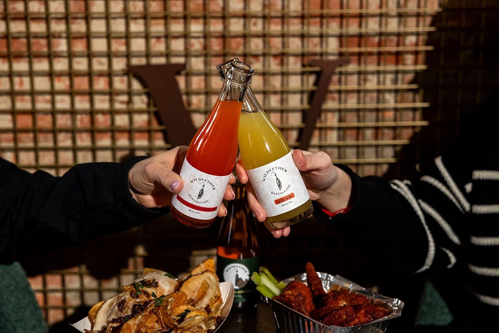 Cheers with to go bottles of cocktails from Wildfether Distillery in Haddonfield NJ