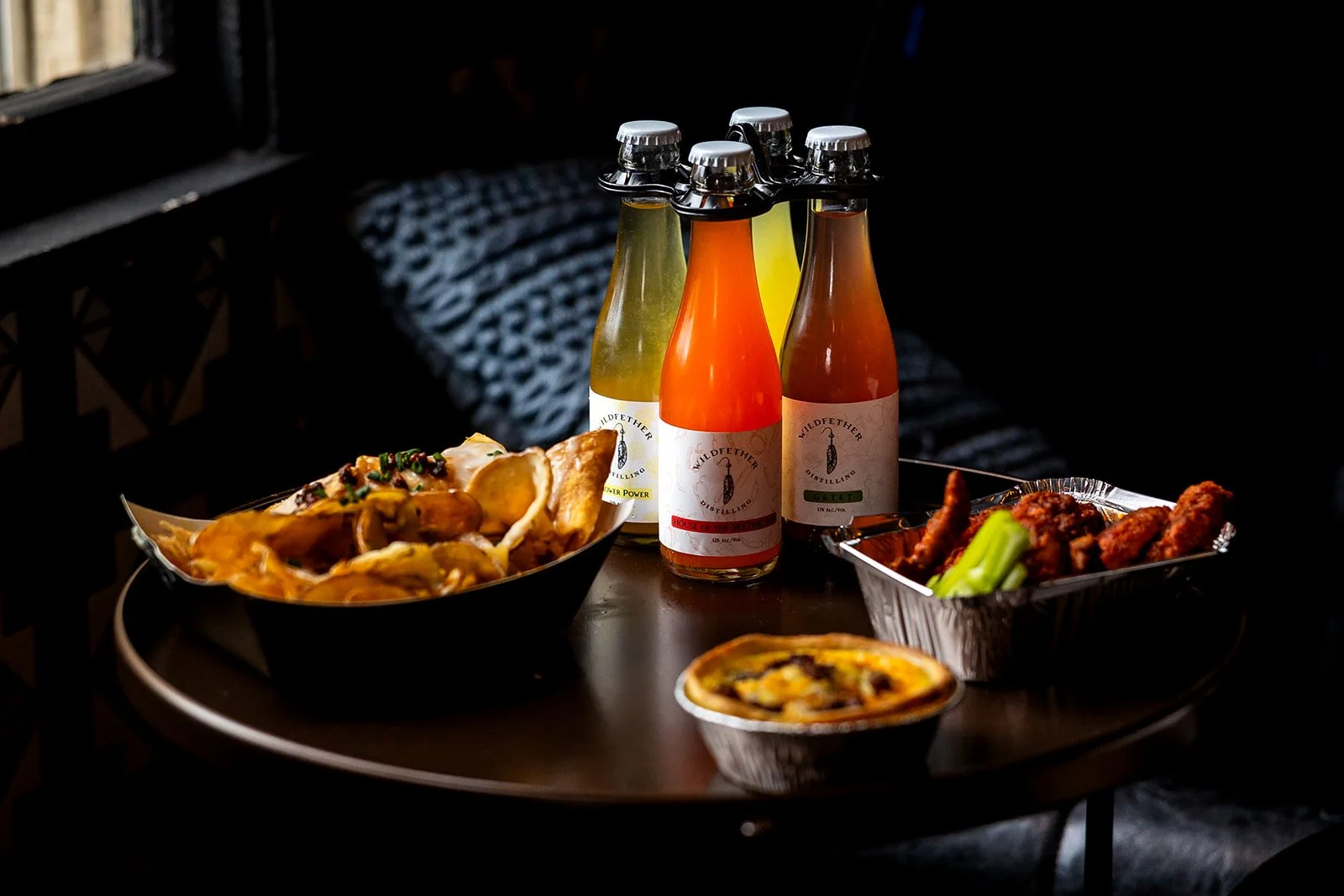 A set of apps and drinks from Wildfether Distillery in the window of their store in Haddonfield NJ