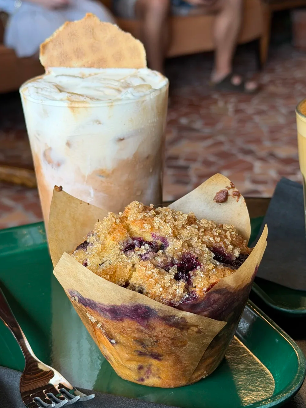 Lemon blueberry muffin next to the Neapolitan iced coffee drink at Godspeed Coffee