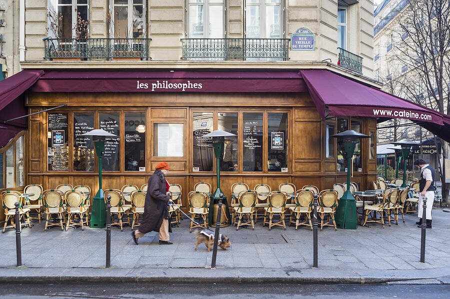 lady-in-orange-cap-walking-her-dog-past-les-philosophes-cafe-on-rue-vieille-du-temple-in-the-marais-paris-david-c-phillips.jpg