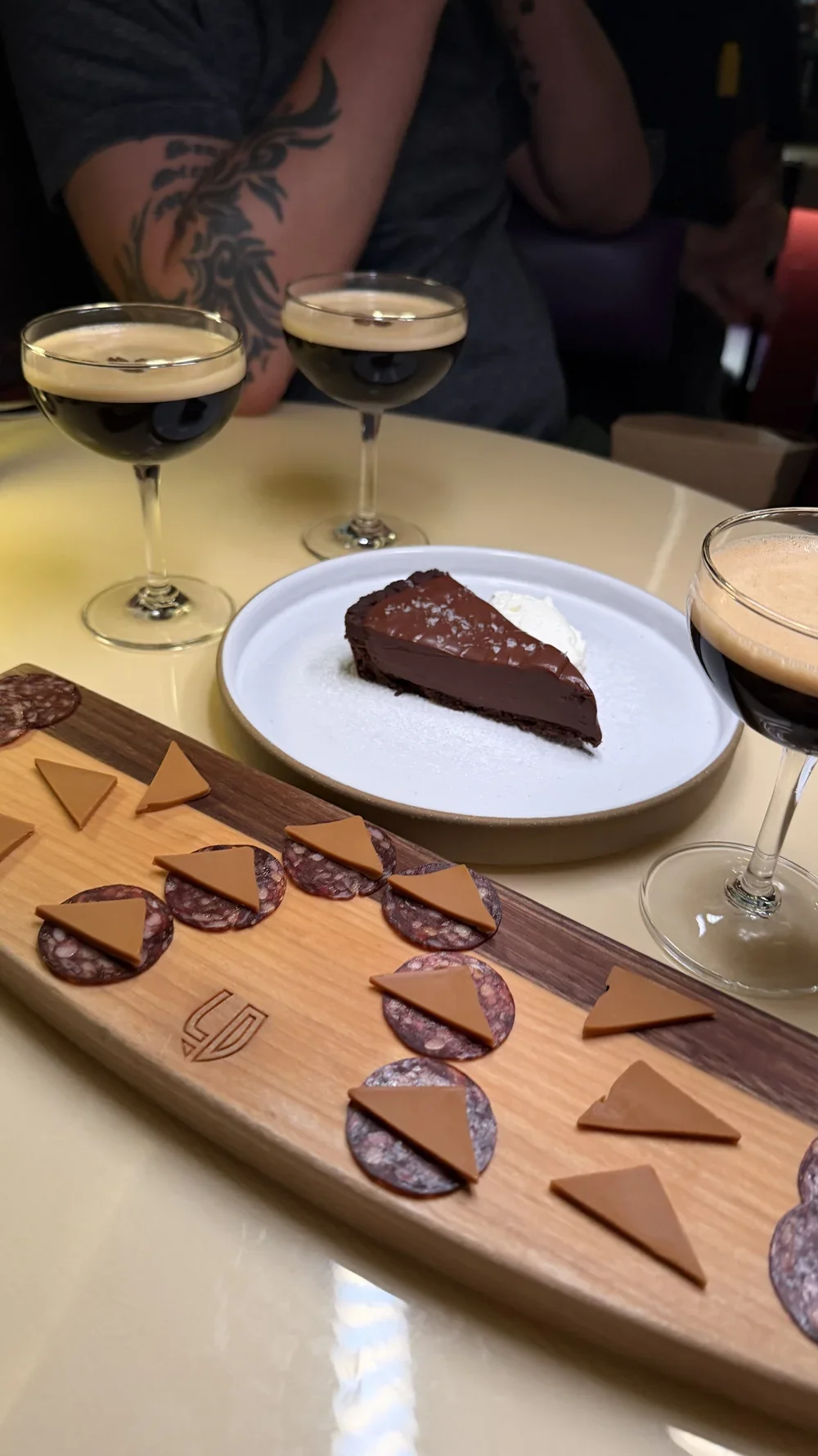 Chocolate tart with flaky salt next to a dessert cheese and charcuterie board at Lula Drake