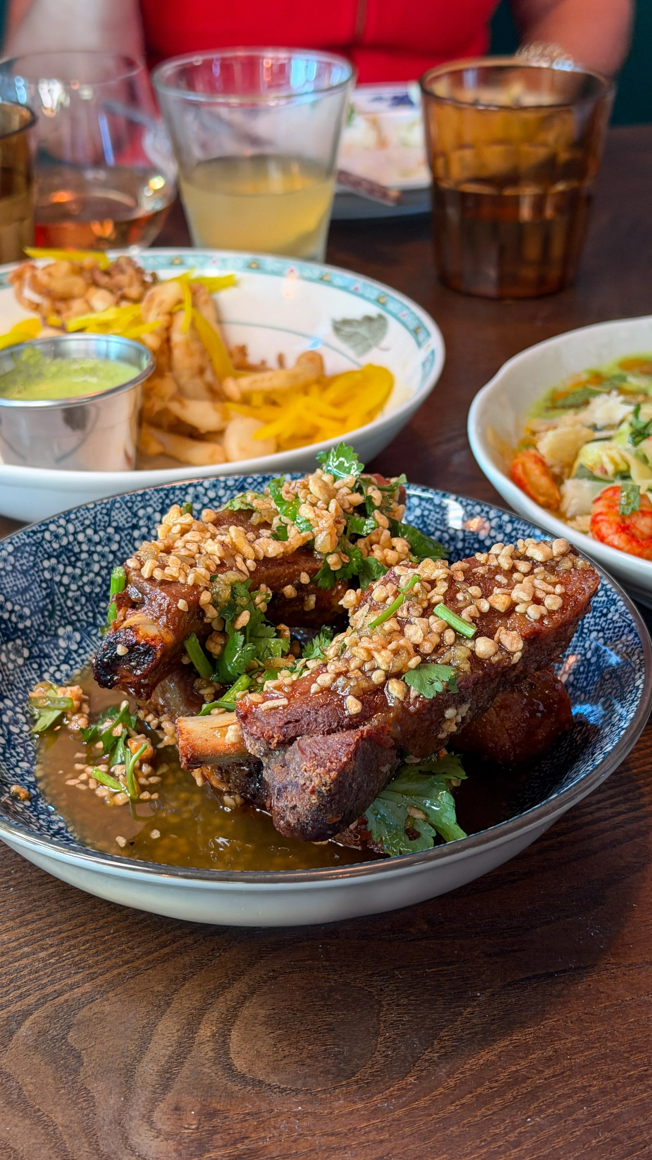 Tamarind ribs topped with fried garlic and herbs at Little Secret