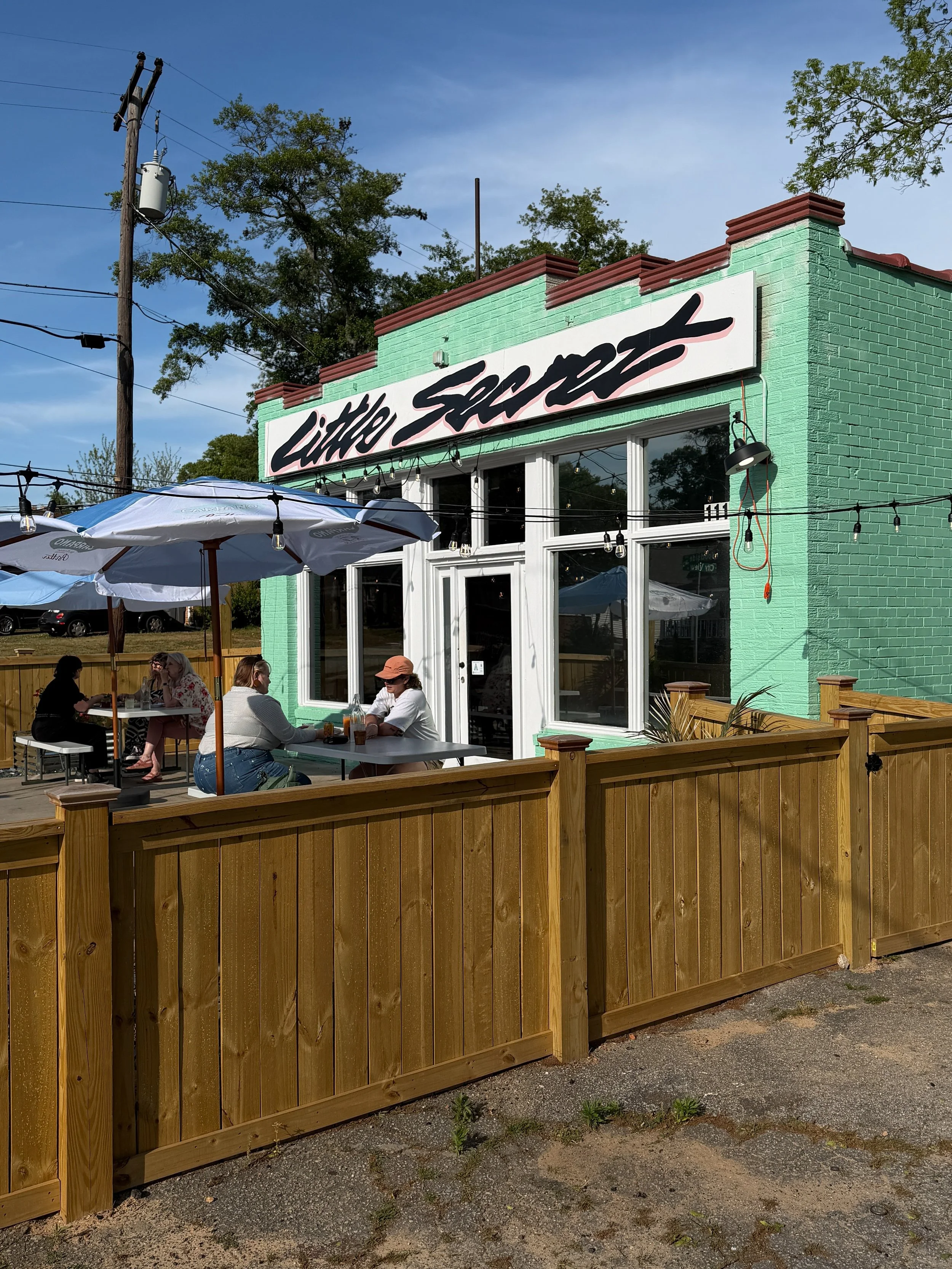Mint green exterior and patio at Little Secret restaurant in Greenville, SC