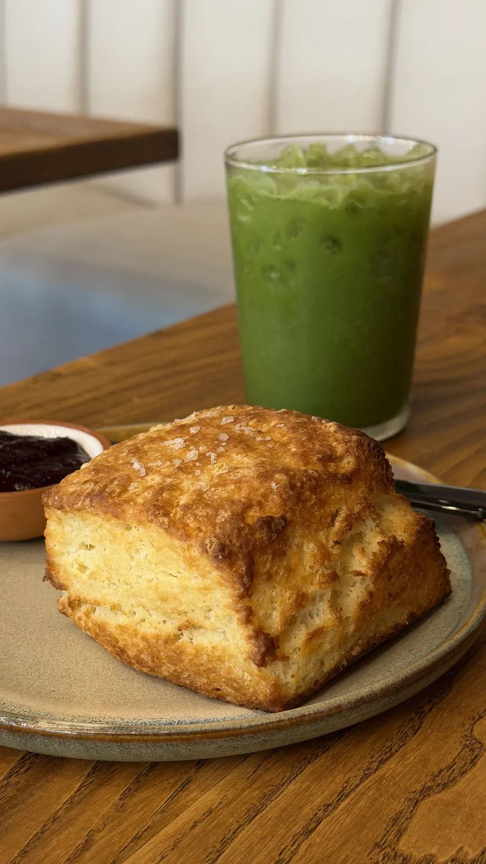 Flaky biscuit with jam and an iced Castaway matcha drink at Nine of Cups in Greenville