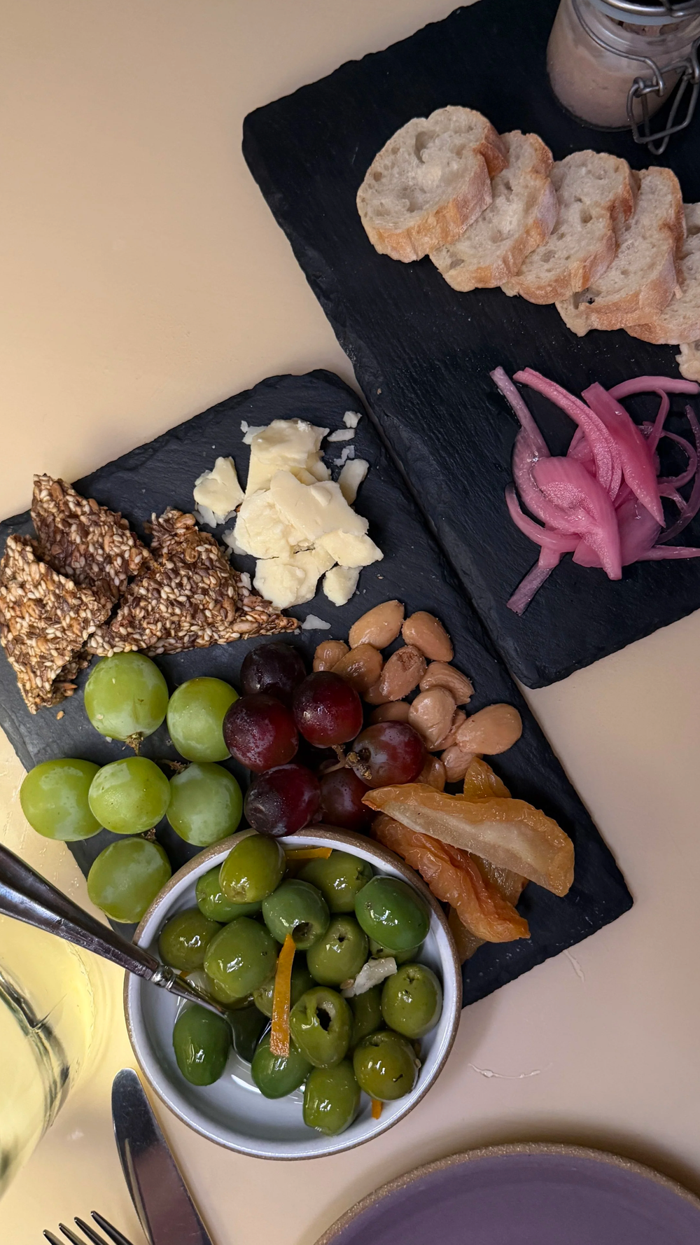 Charcuterie board with cheese, grapes, olives, and nuts at Lula Drake Wine Parlour