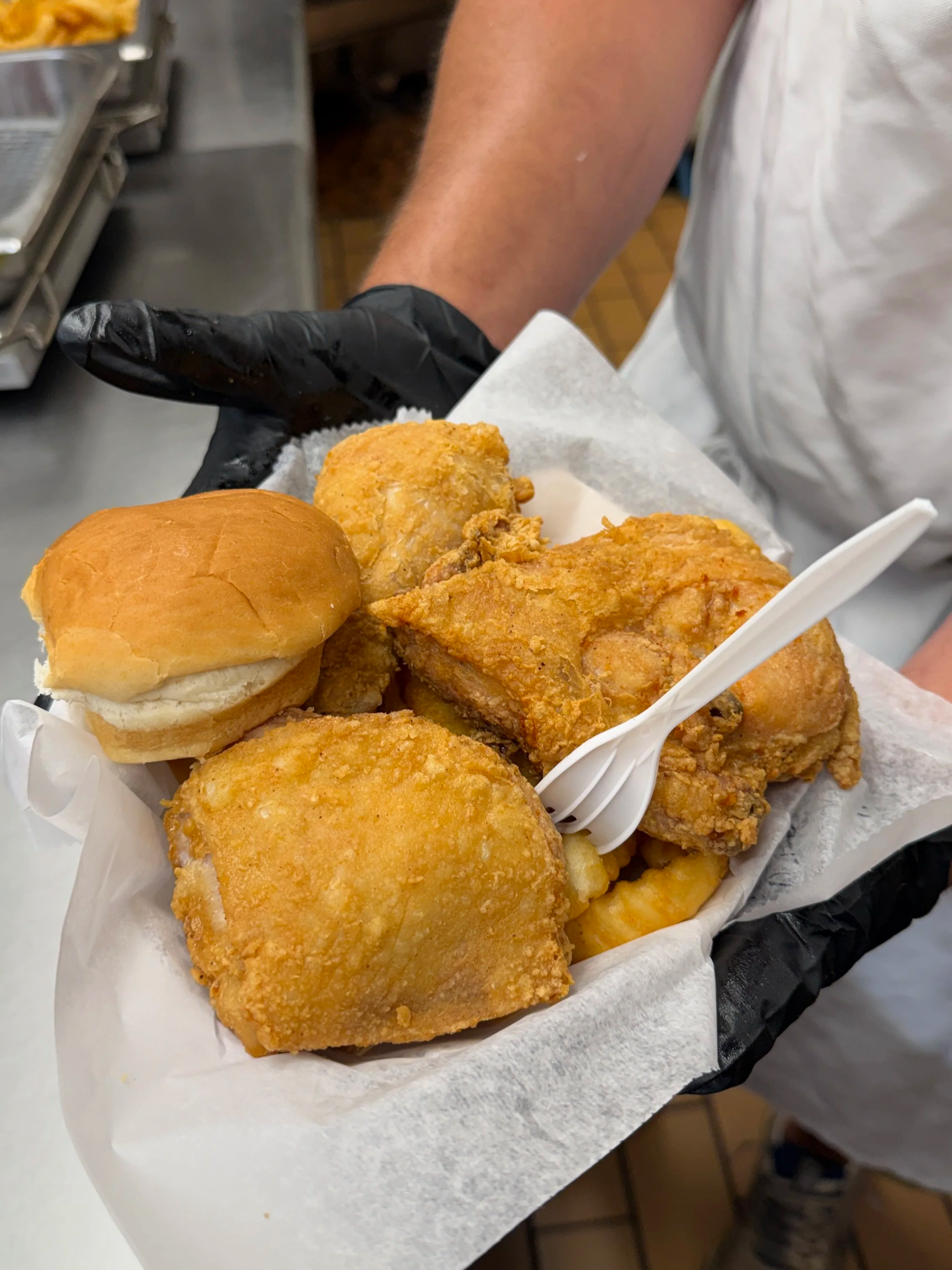 Bernie's 3-piece Chicken Special with a dinner roll in a to-go container