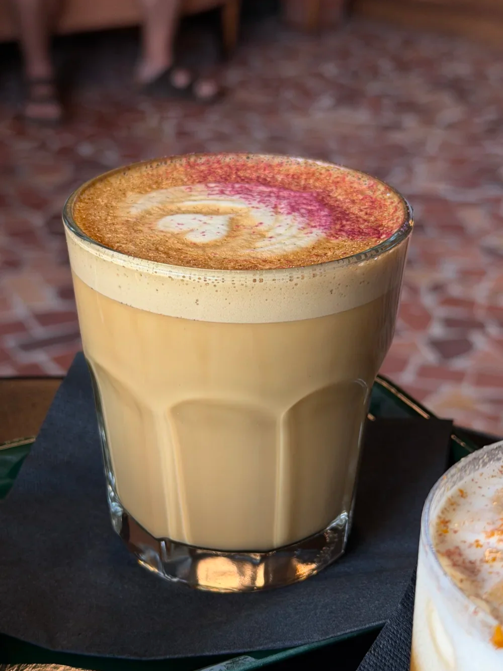 Close-up of The Nectar latte with saffron and rose dust at Godspeed Coffee