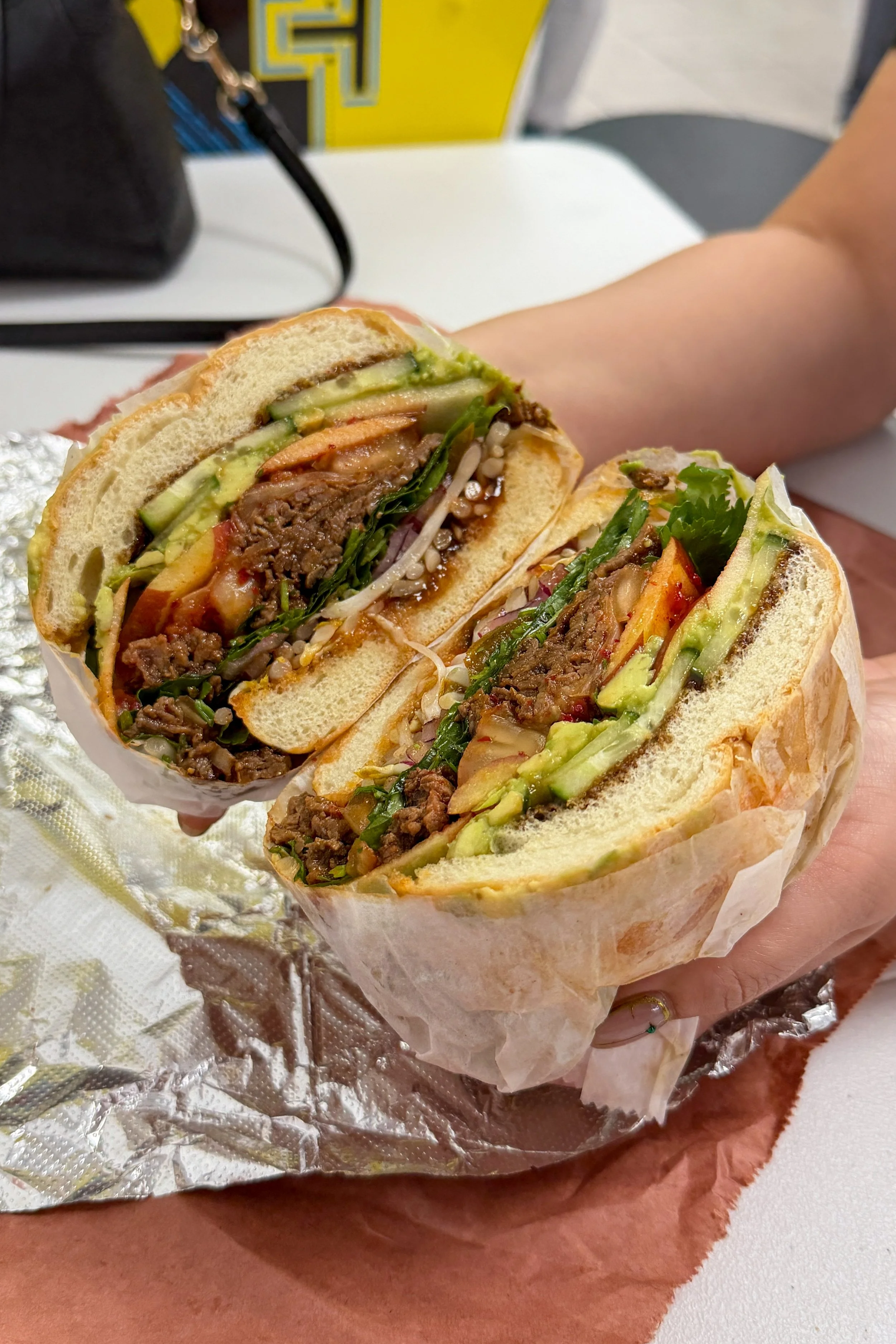 The Bulgogi Pho sandwich at Mochi's Deli in Charlotte, loaded with bulgogi beef, cucumber, apple, avocado, and cilantro
