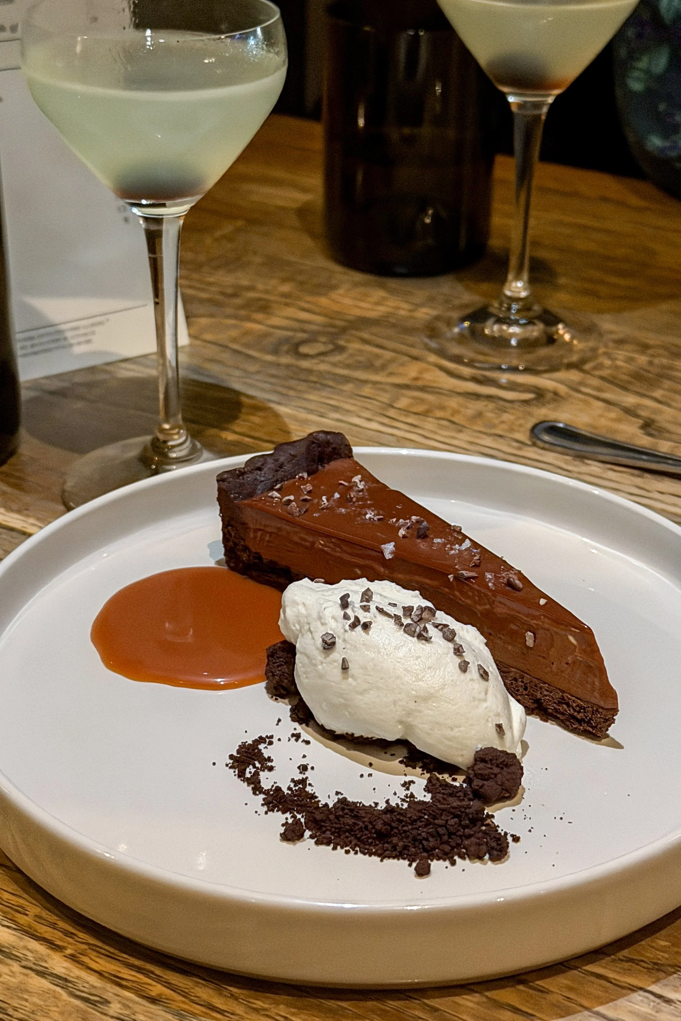 The Valrhona Chocolate Mousse Tart at J.C. Holdway in Knoxville, topped with sea salt, whipped cream, and a pool of caramel sauce