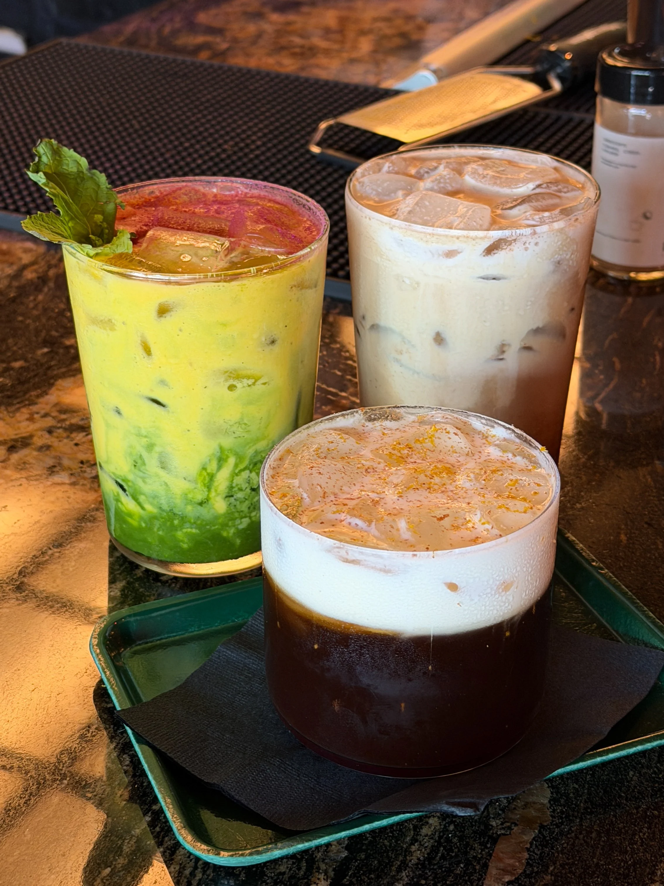 Mango lassi matcha special, PB&J iced coffee, and The Magpie together at Godspeed Coffee