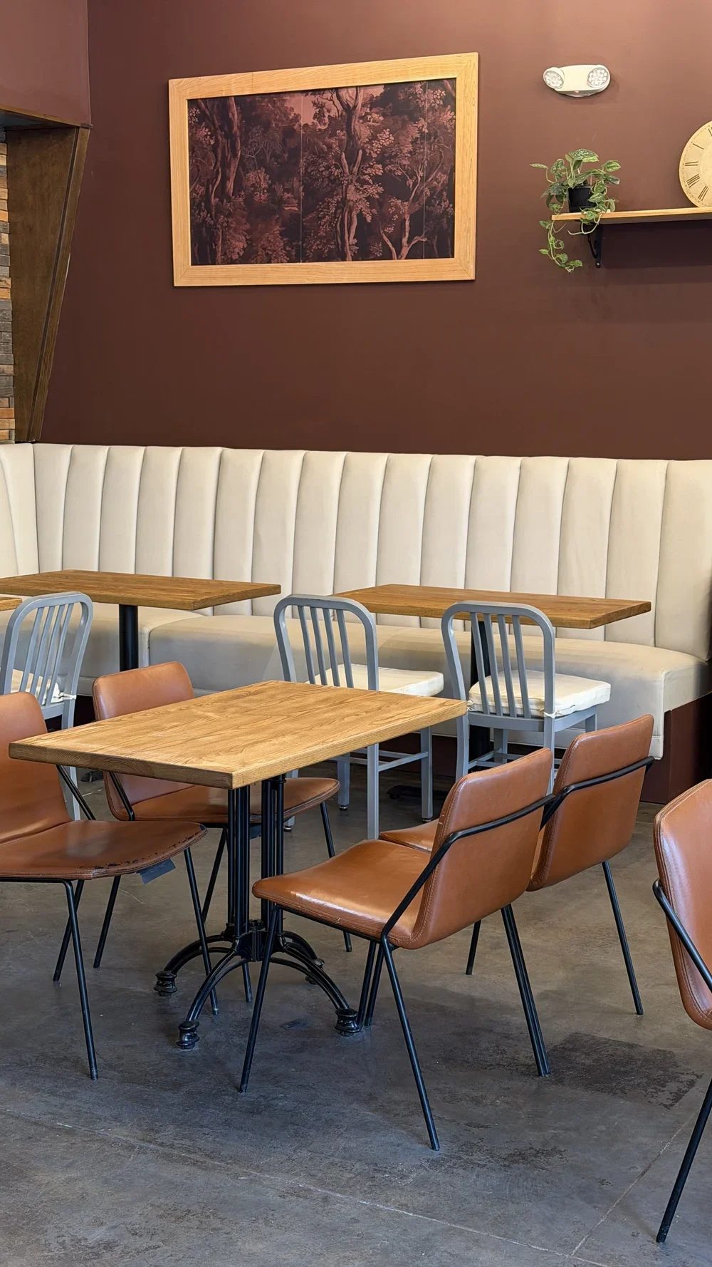 Dining room seating with leather chairs and a cream banquette at Nine of Cups in Greenville