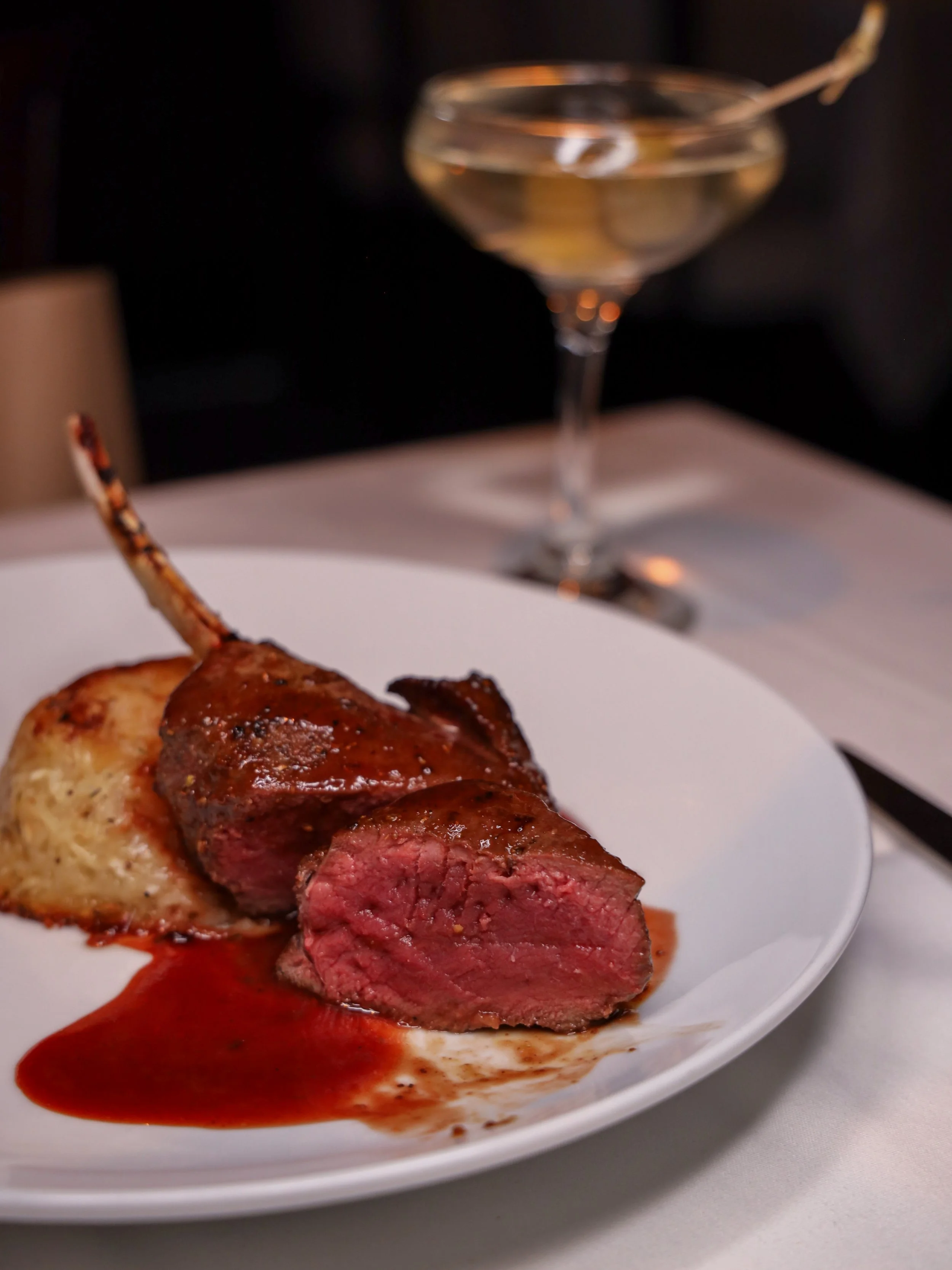 A closer view of the Spiced Cervena Elk Rib Chop at Ristorante Paoletti, showing its rosy pink center.