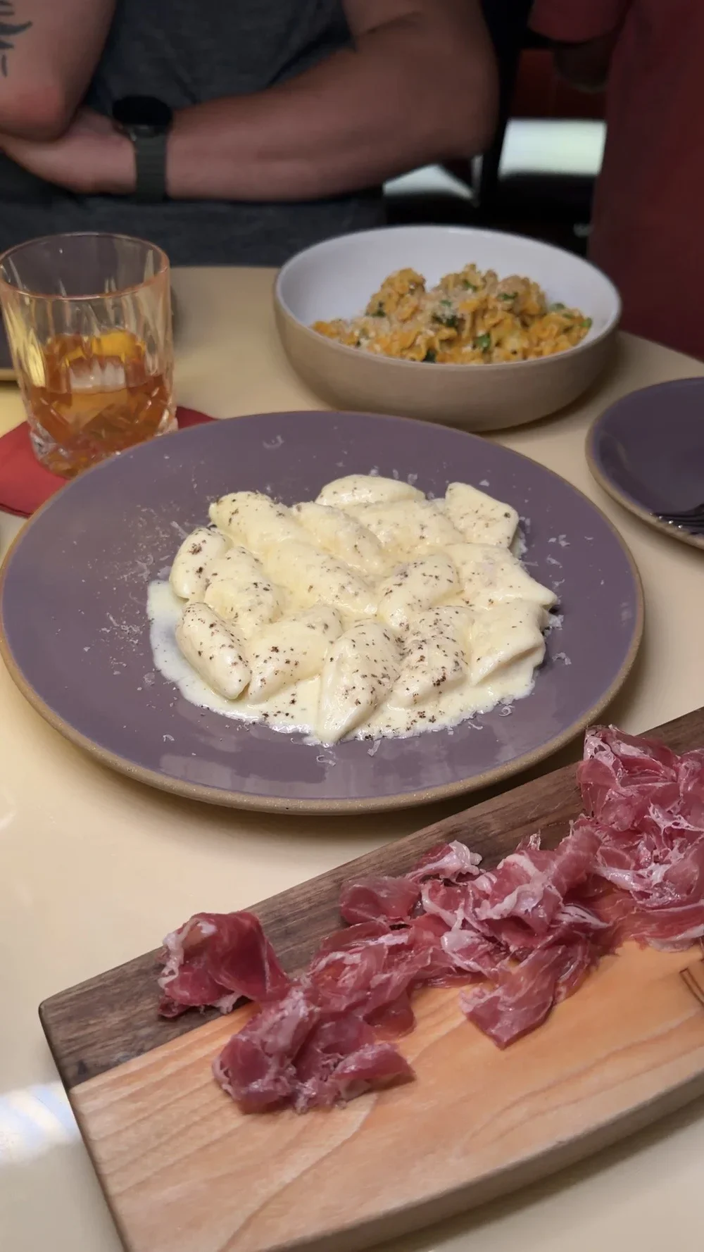 Cacio e Pepe gnudi next to sliced Capa Negra Jamón Ibérico at Lula Drake Wine Parlour