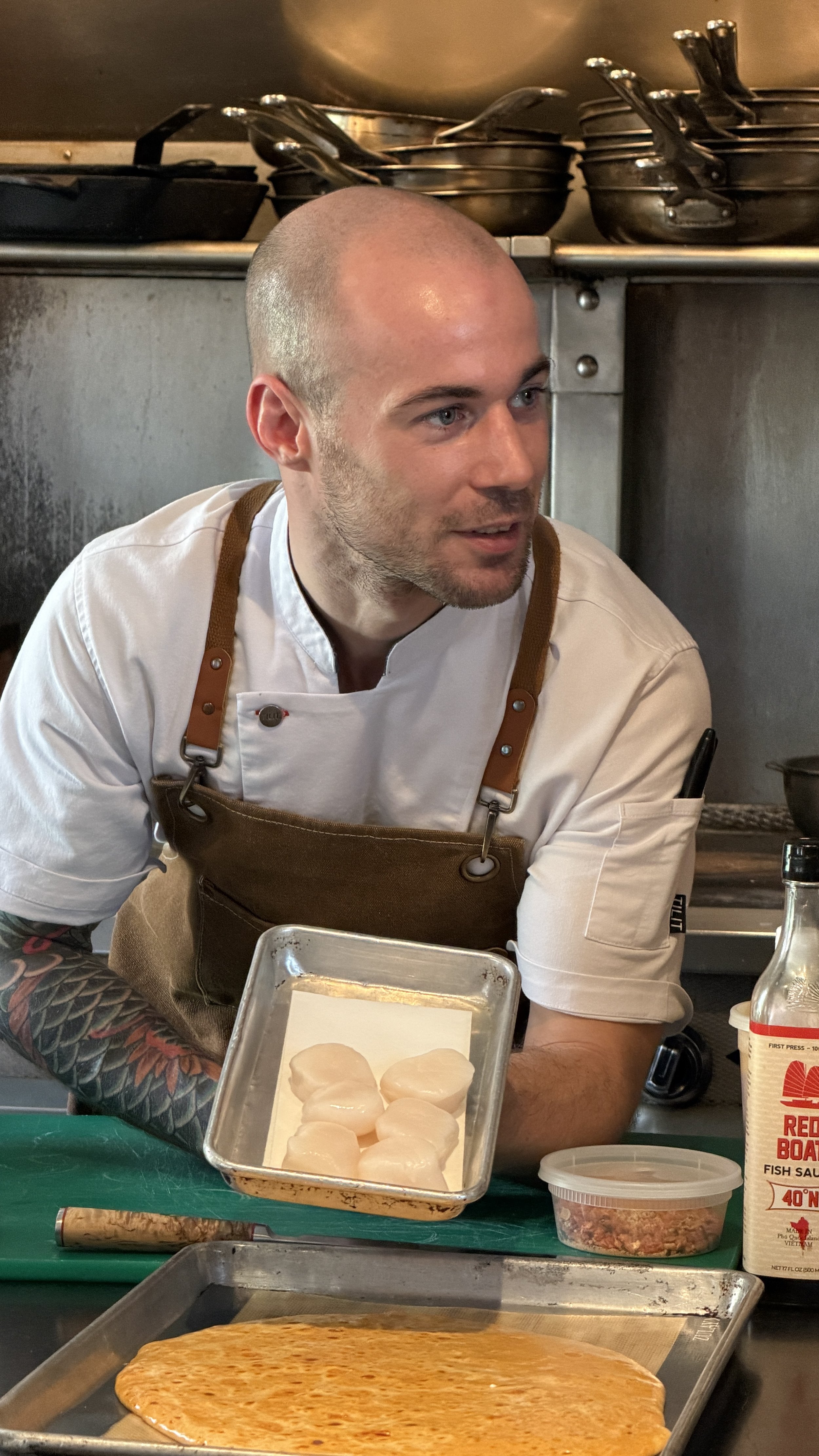 Chef Roberto explaining day boat scallop preparation during a Zero George cooking class