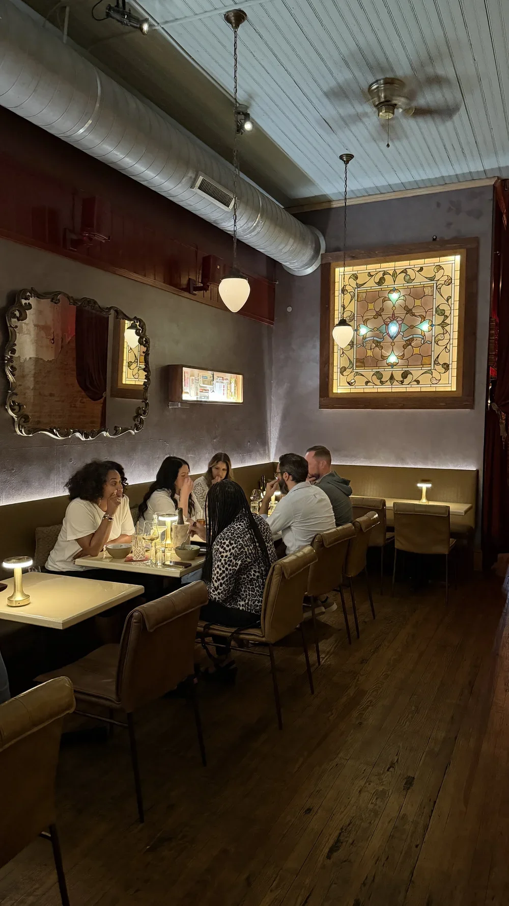 Dining room with stained glass and vintage decor at Lula Drake Wine Parlour in Columbia