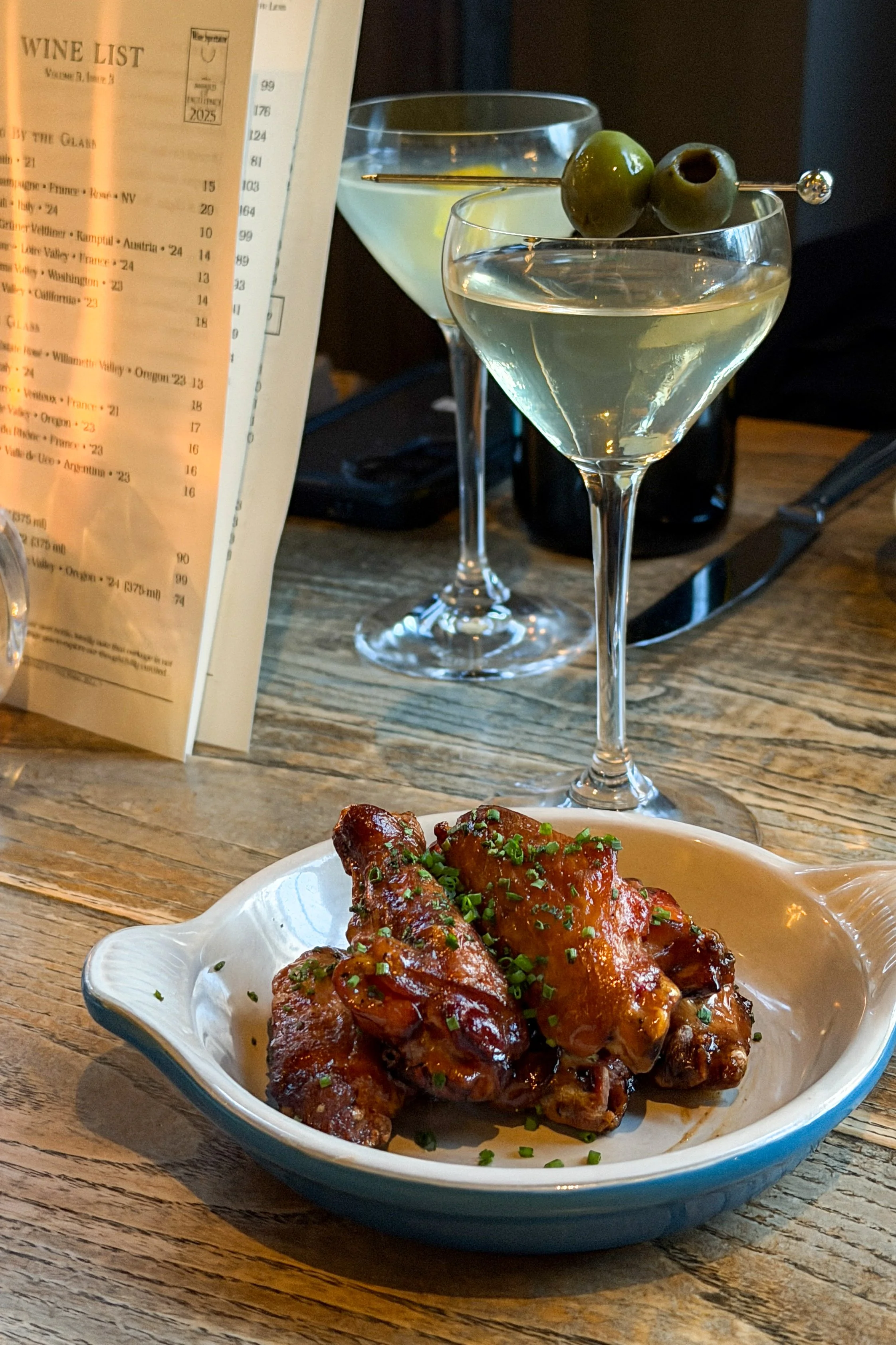 The wood-fired chicken wings at J.C. Holdway in Knoxville, glazed and sticky with a scattering of fresh chives