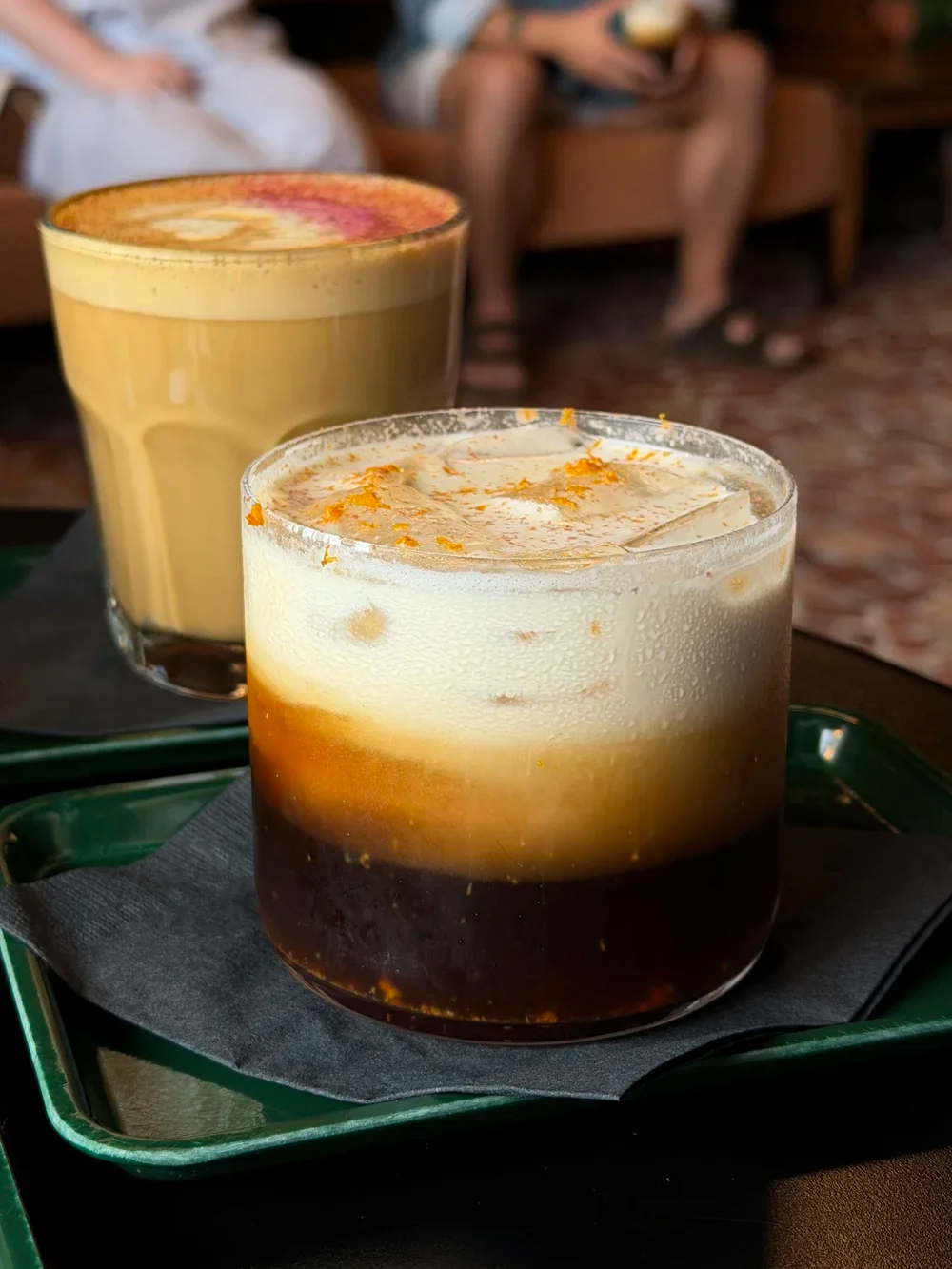The Magpie espresso drink with orange zest next to The Nectar latte at Godspeed Coffee
