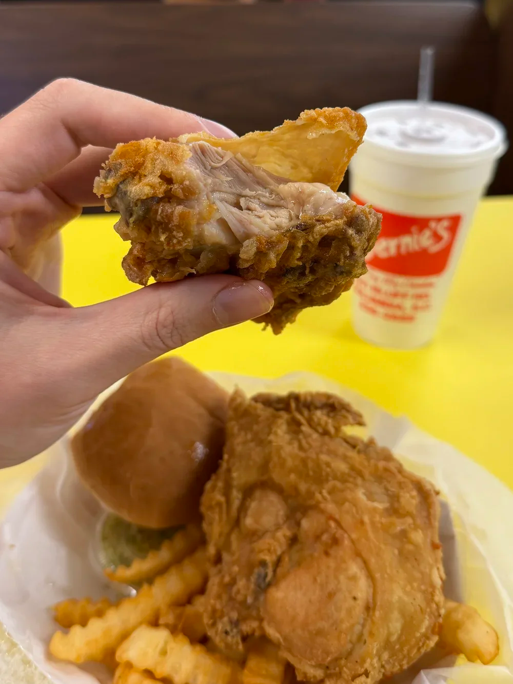 Close-up of broasted chicken showing the juicy interior at Bernie's Chicken